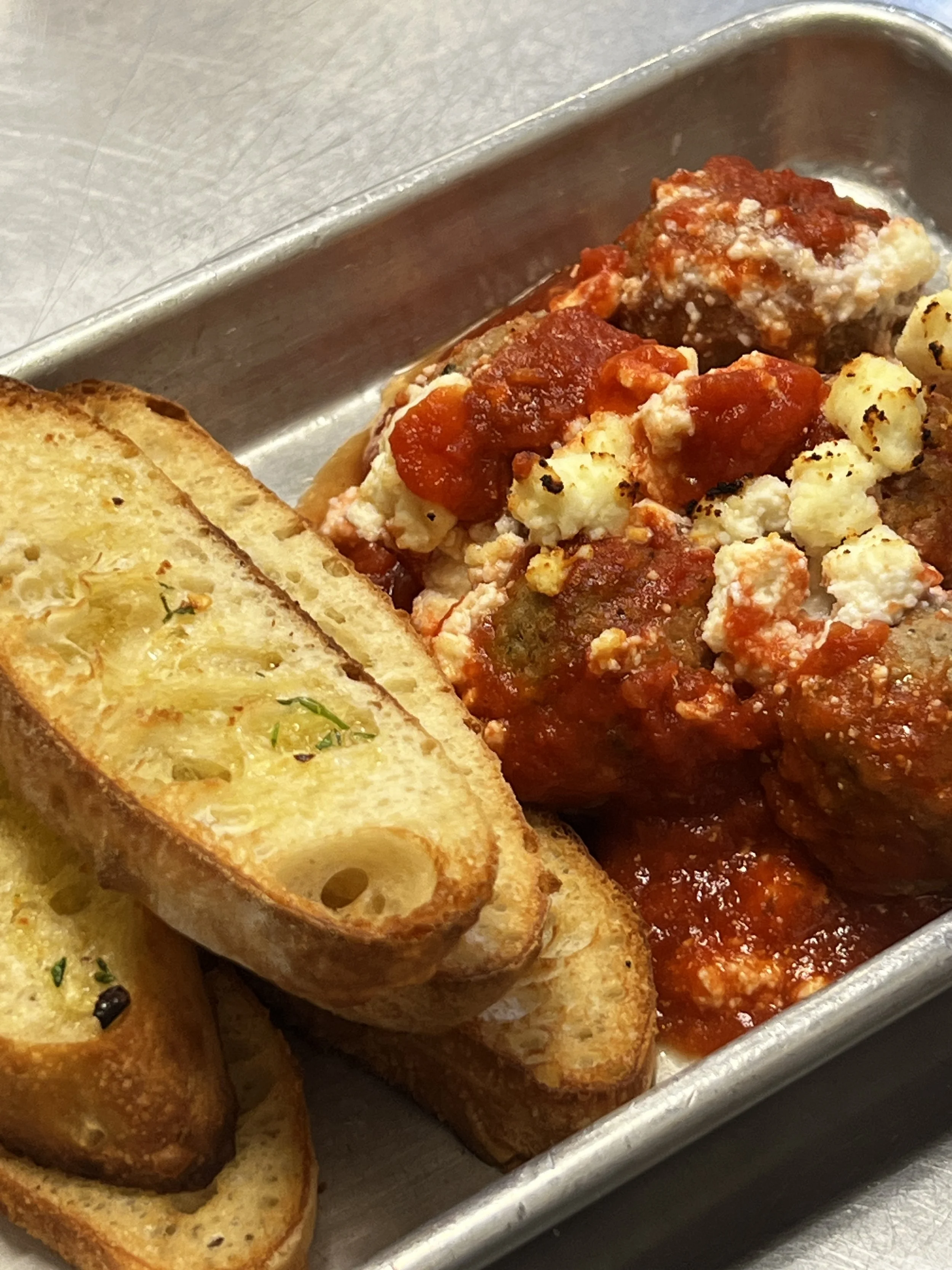 Meatball appetizer in sauce with garlic bread at Kechy Pizza Co, Westminster, MD