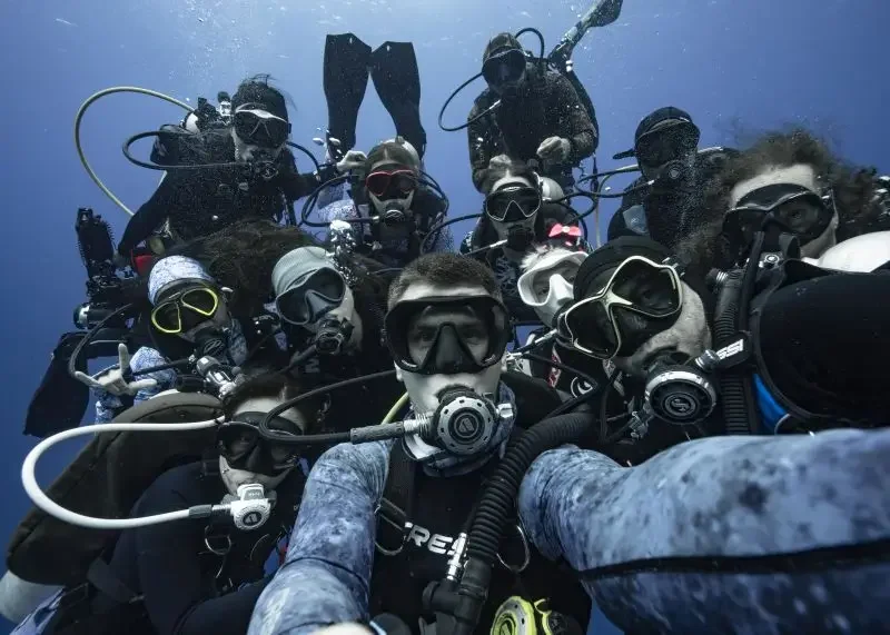 A selfie of a Pixel Expeditions diving group taken while on a trip in Palau