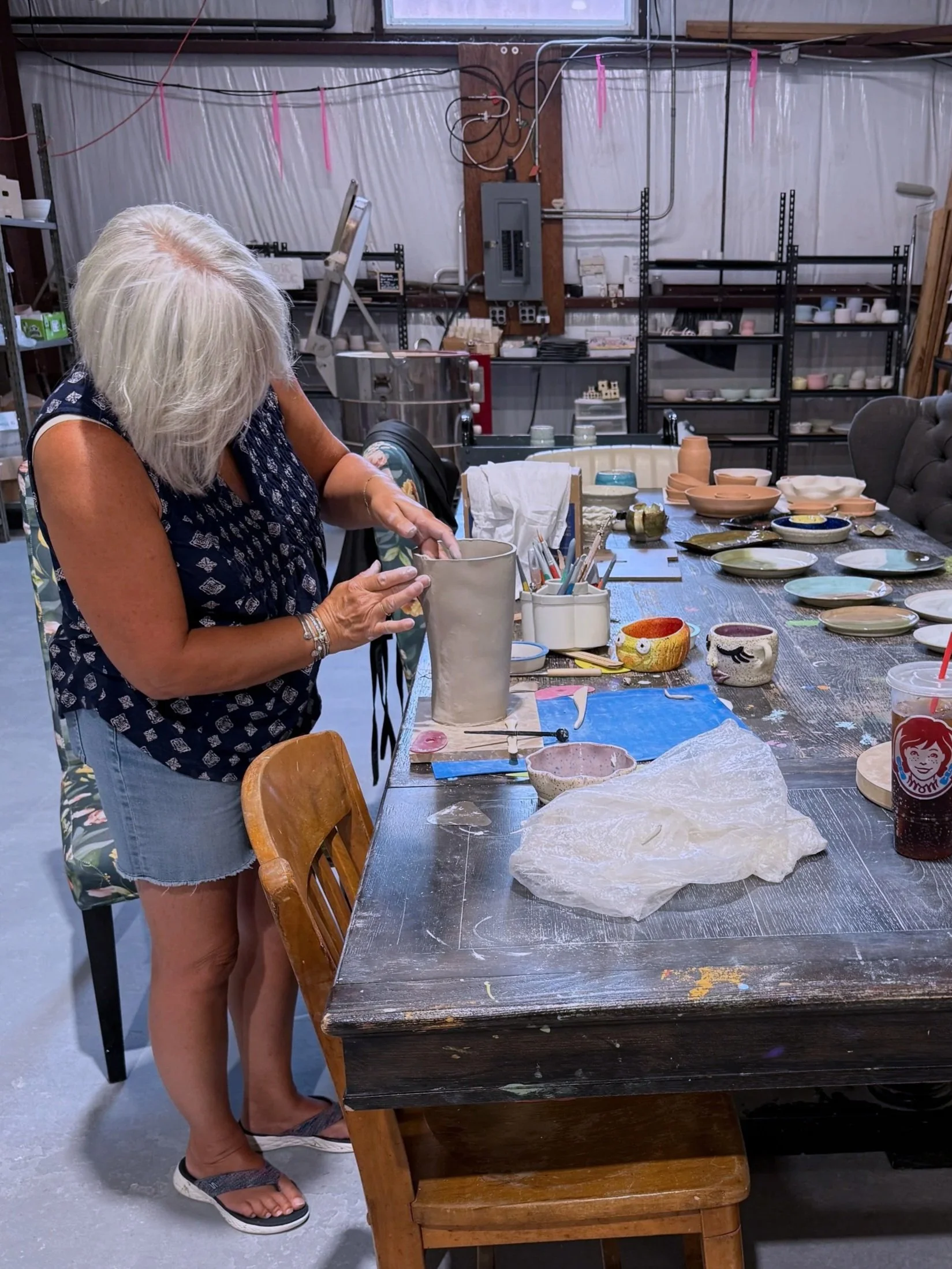 woman handbuilding pottery at grit &grog in agawam
