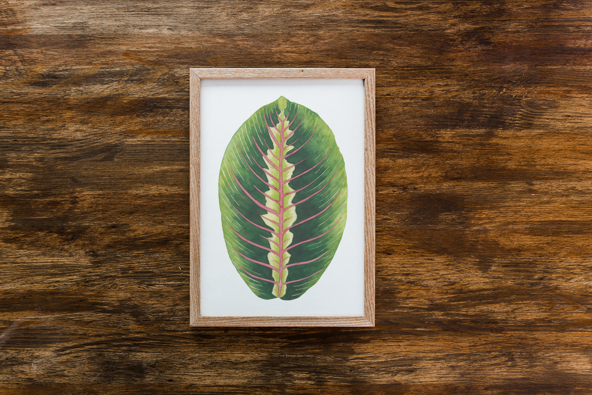 mockup-of-a-framed-art-print-placed-on-a-wooden-surface-36126-r-el2 (2).png