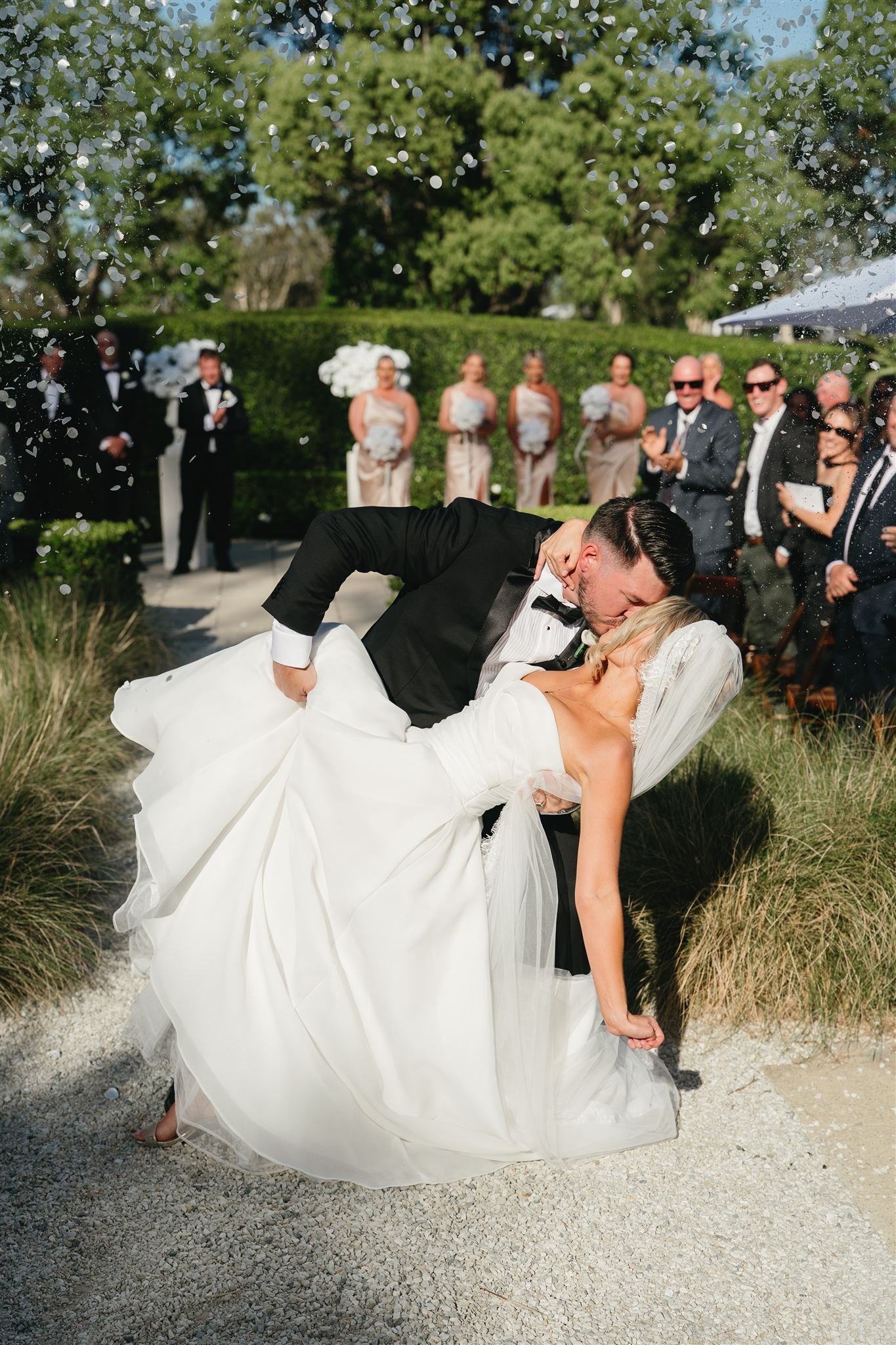 Wedding at Braeside Estate. Shanice and Brodie kissing at the end of the aisle. Confetti floating around them. Married by Ellen Carey Marriage Celebrant. Gold Coast. Byron Bay. Northern Rivers. Marriage Celebrant.
