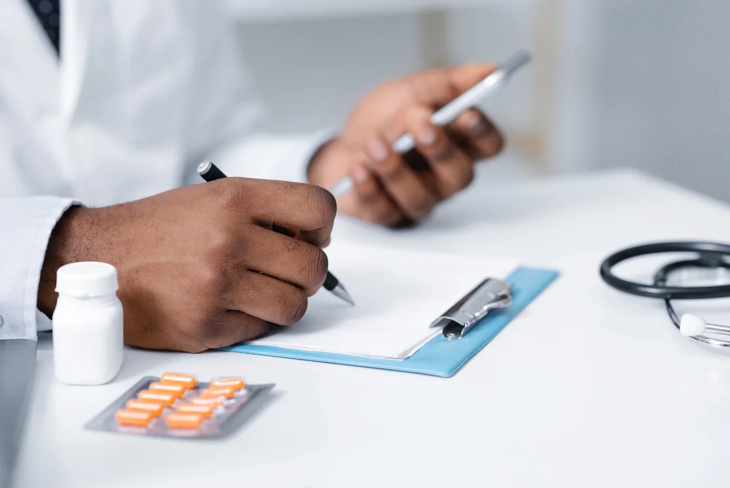 Doctor writing a prescription on his notepad for a psychiatry patient