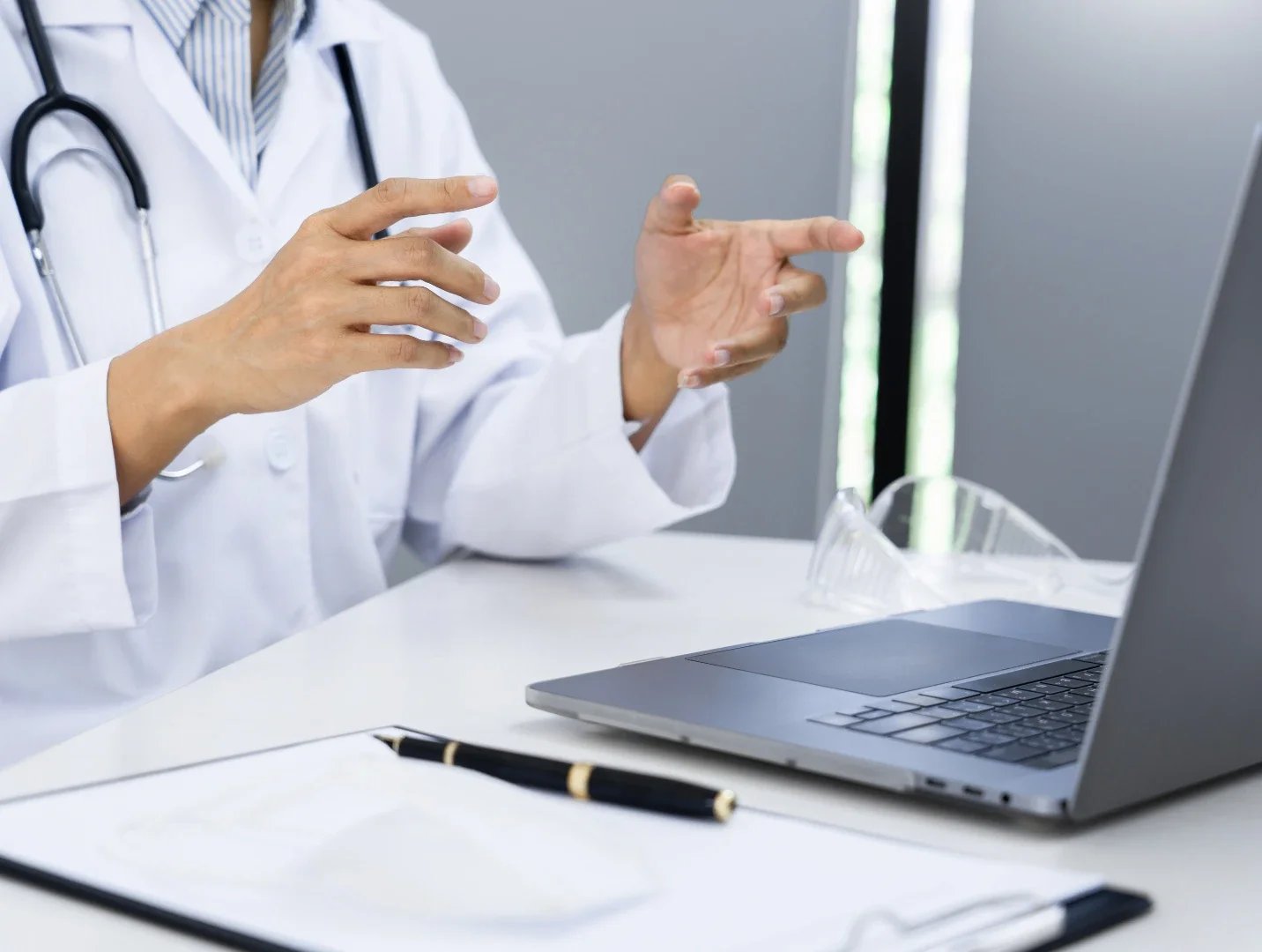 Psychiatrist follow up visit with patient via telehealth on laptop