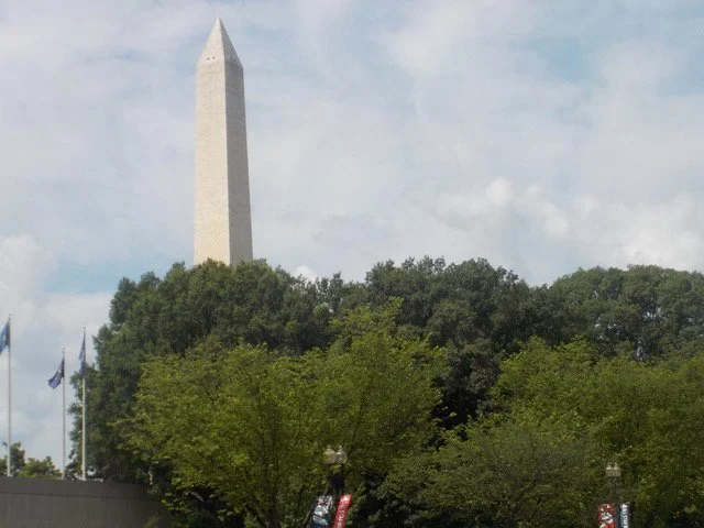 This is a photo of the Washington Monument in Washington DC. The Monument is made in the shape of an obelisk. This design has its origins in Egypt. It was built to honor George Washington, the first President of the United States. It was completed on