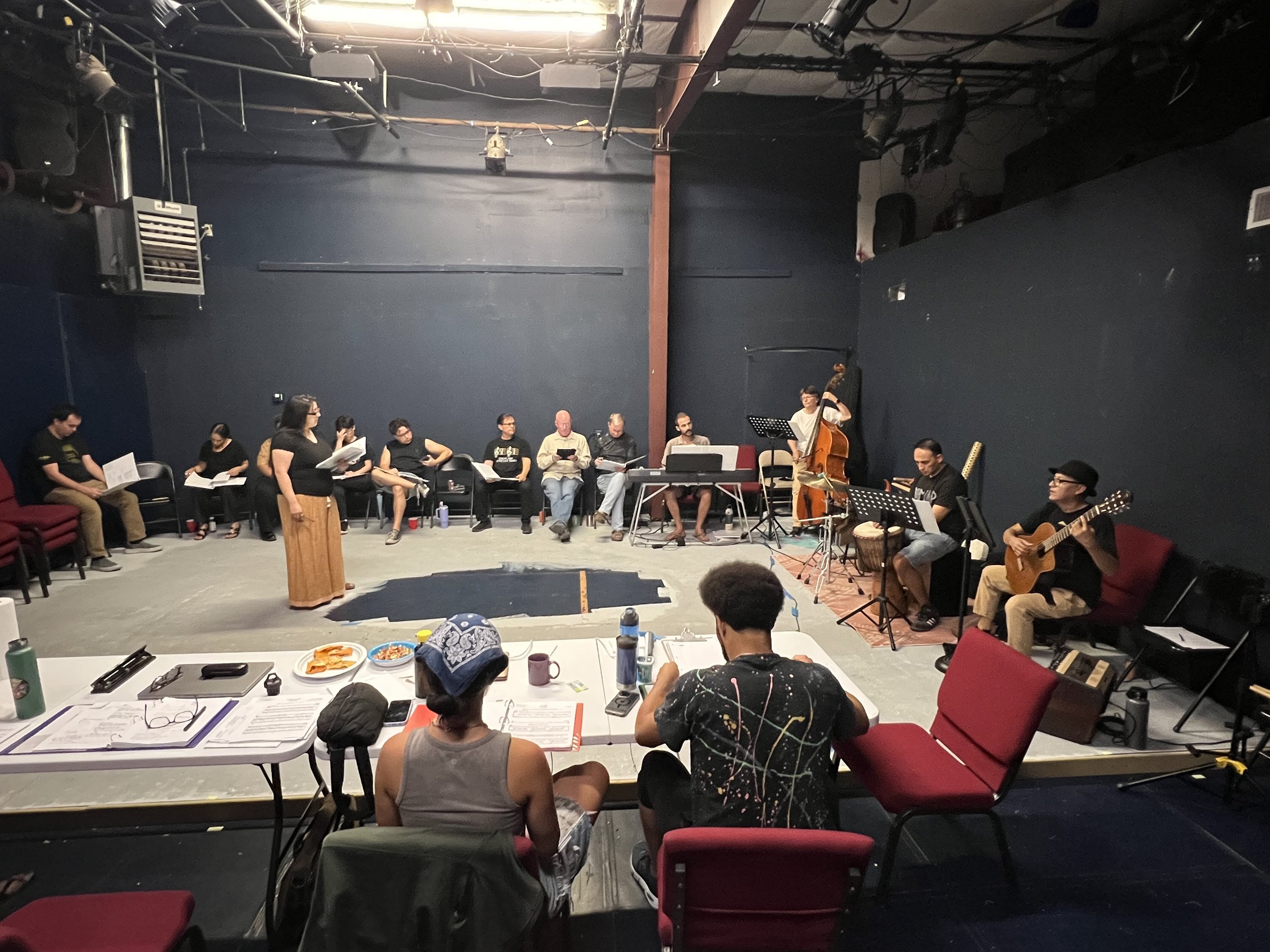 The team rehearses with Justin and Marina taking notes.jpeg