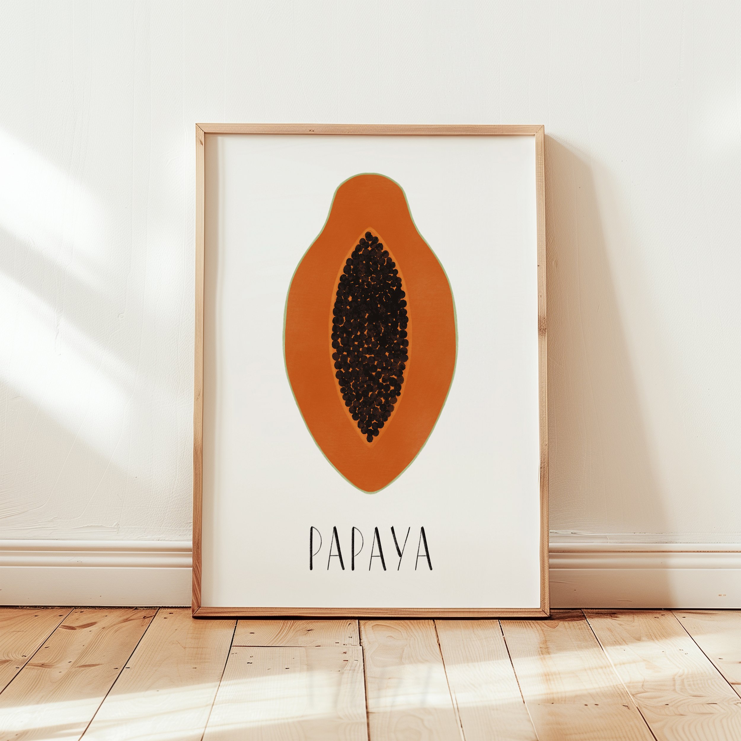 Ein gerahmtes Poster mit einer stilisierten Papaya-Silhouette, die mit schwarzen Samen gefüllt ist, steht auf einem Holzboden gegen eine weiße Wand. Darunter steht in schwarzen Buchstaben "PAPAYA".