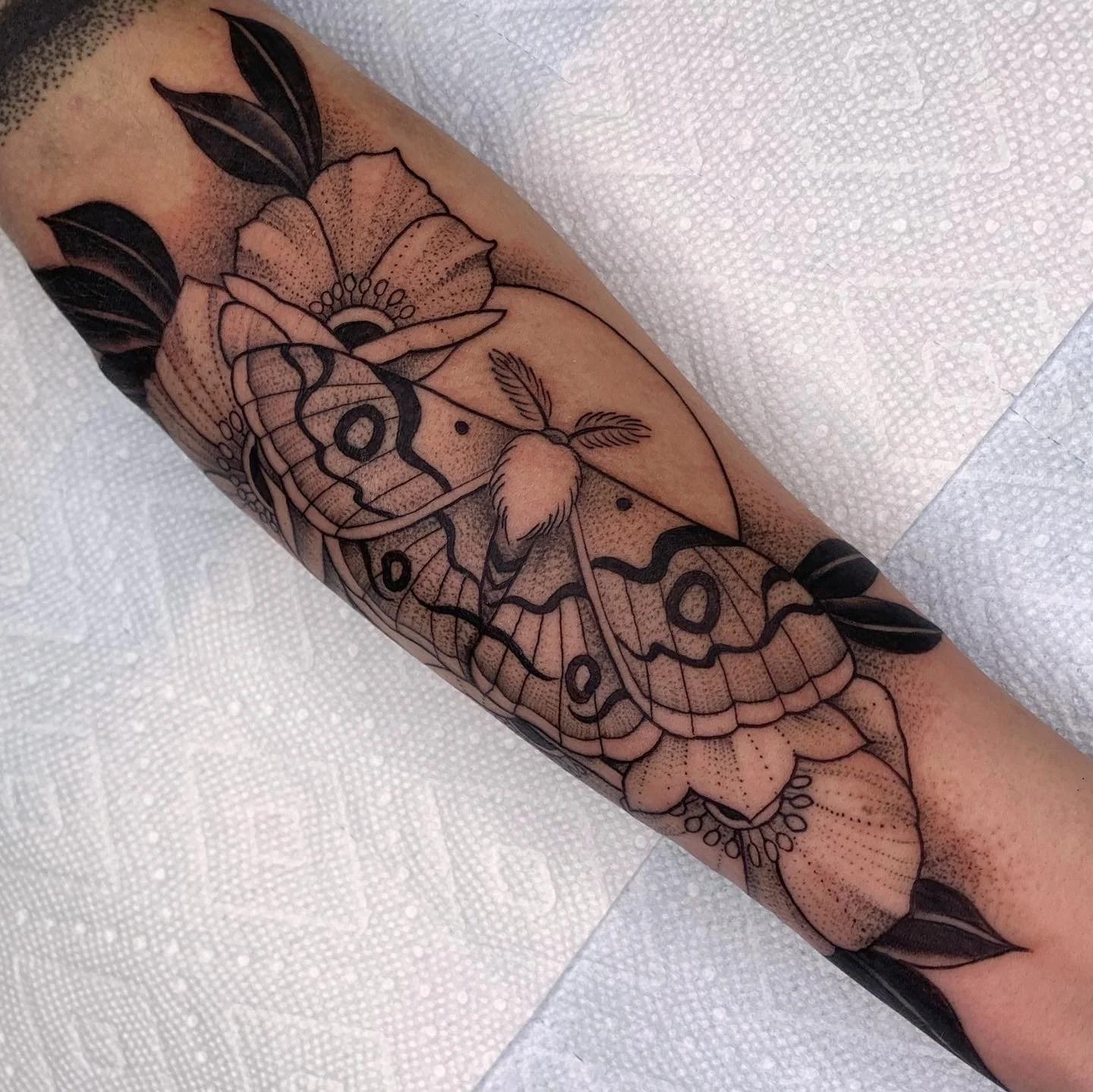 moth tattoo, dotwork, tattoo moon, forearm, leaves blossoms