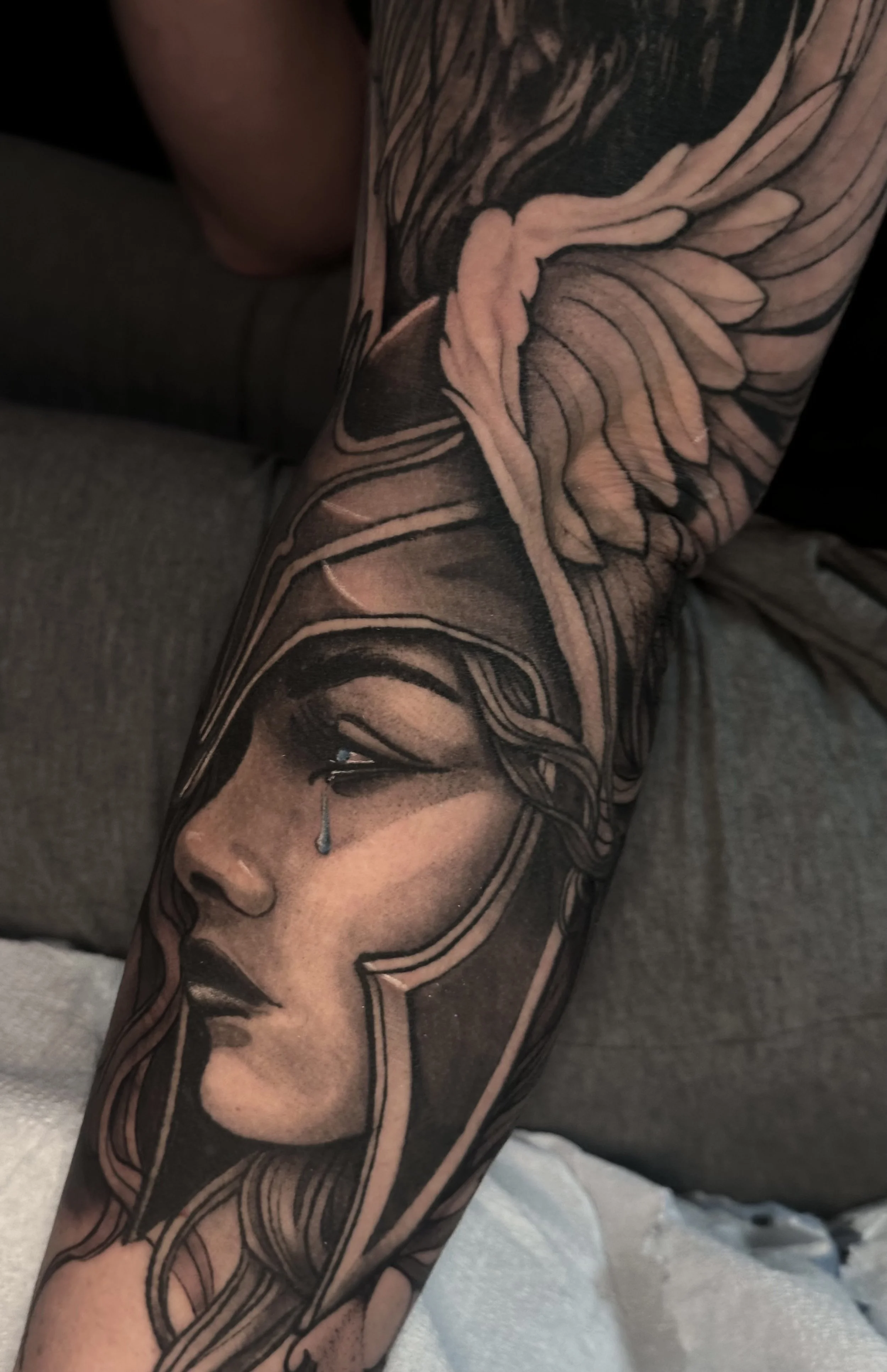 black and gray illustrative realistic tattoo of valkyrie woman with winged helmet on forearm by edgar rodriguez in colorado