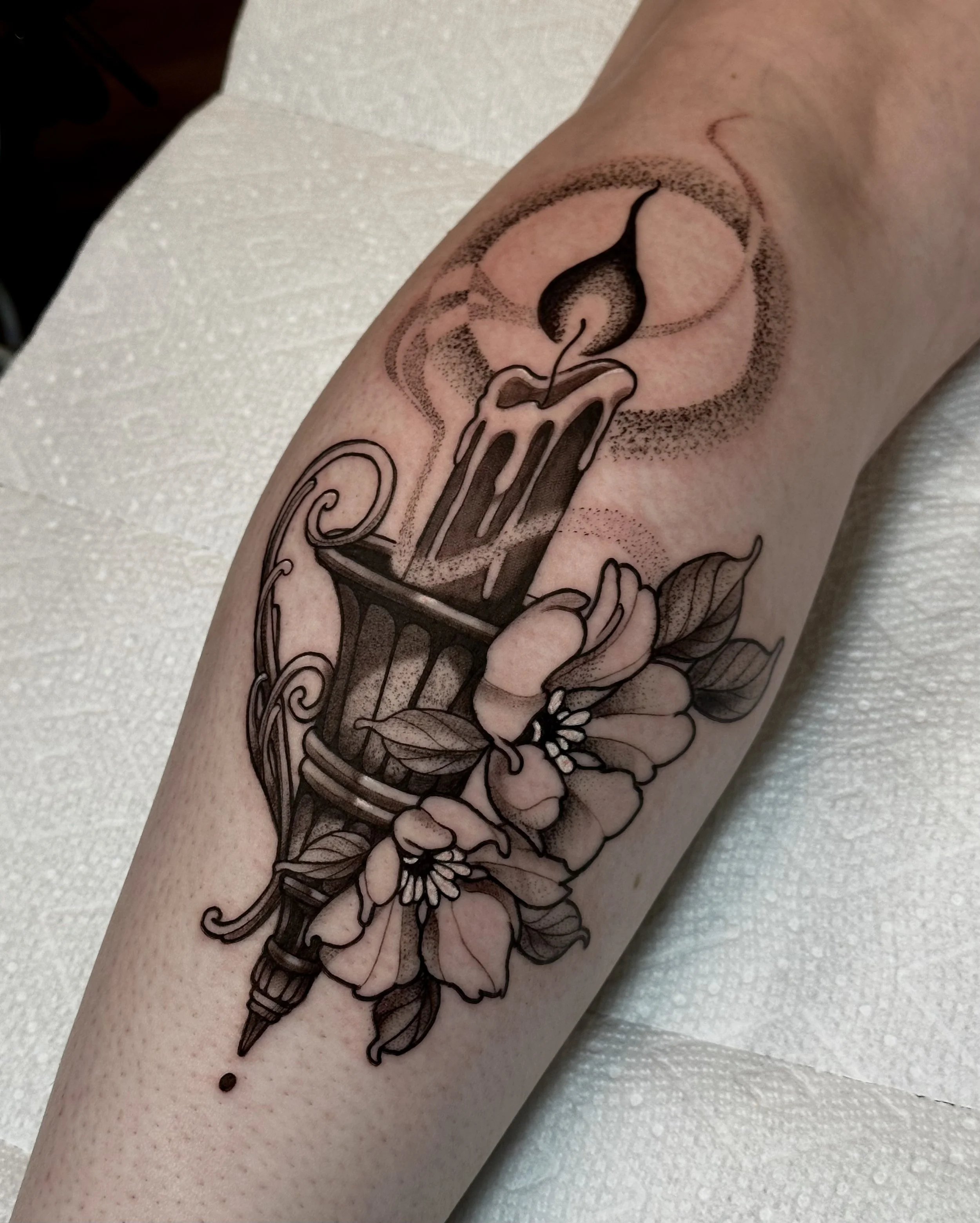 Illustrative  candle tattoo with blossoms on the calf by Edgar.tattoos in colorado springs
