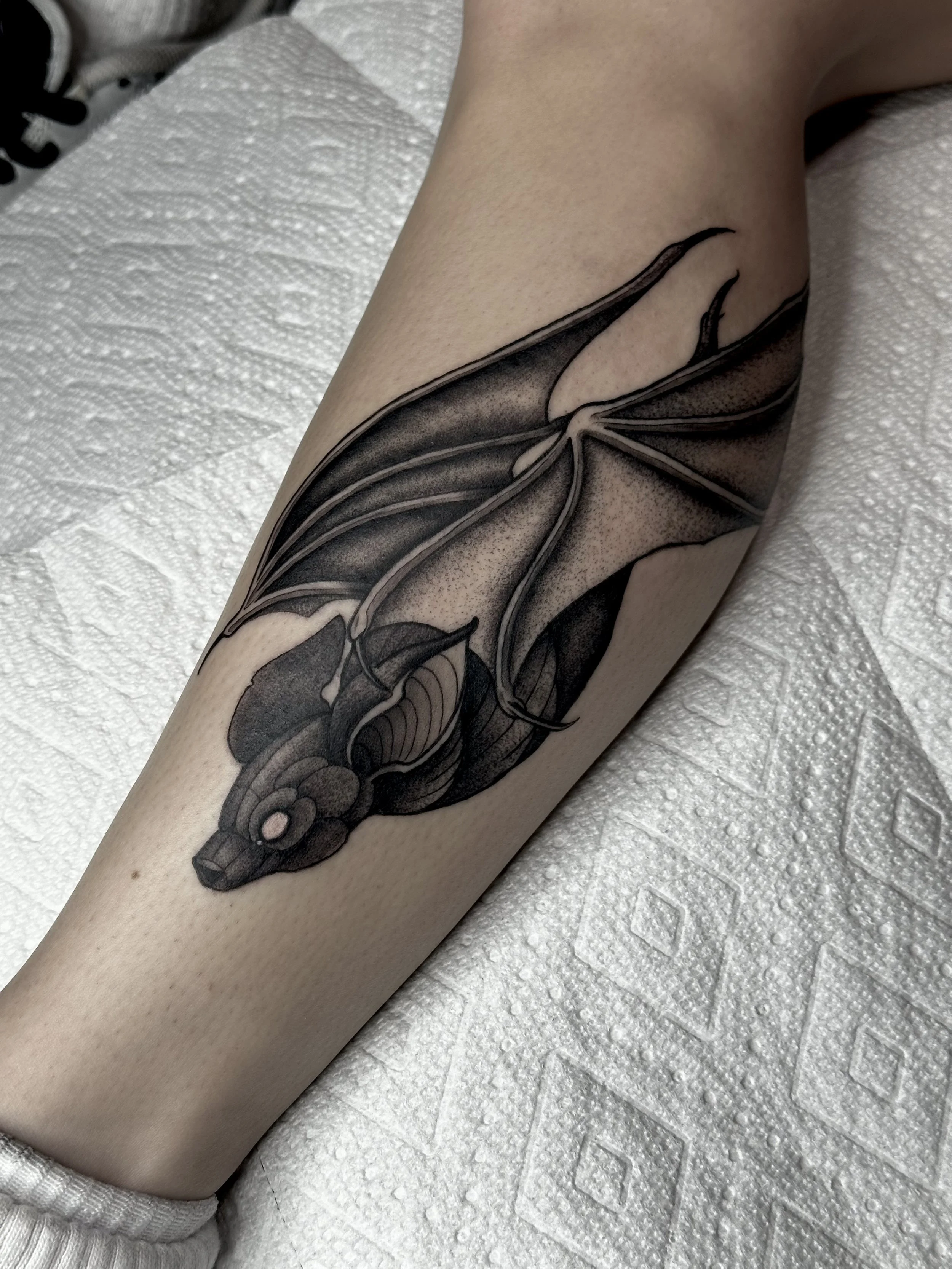 bat tattoo, blackwork, illustrative, calf tattoo, cute bat tattoo