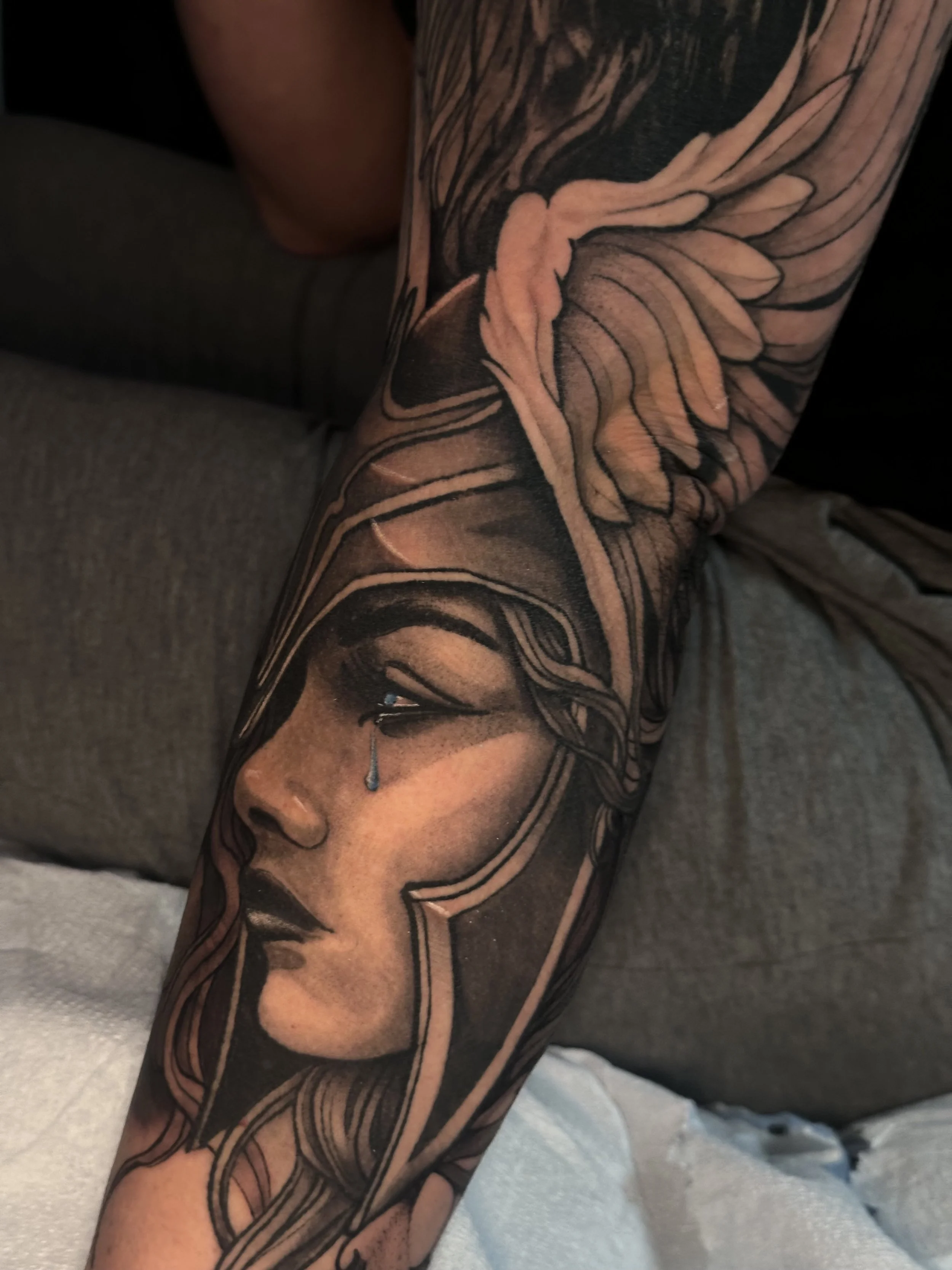Valkyrie tattoo, Valkyrie helmet, wing, feathers, realistic lady face, black and gray, large, sleeve black and grey sleeve, Colorado Springs, Colorado Tattoo artist, realism, realistic, neotraditional, neoromanitic