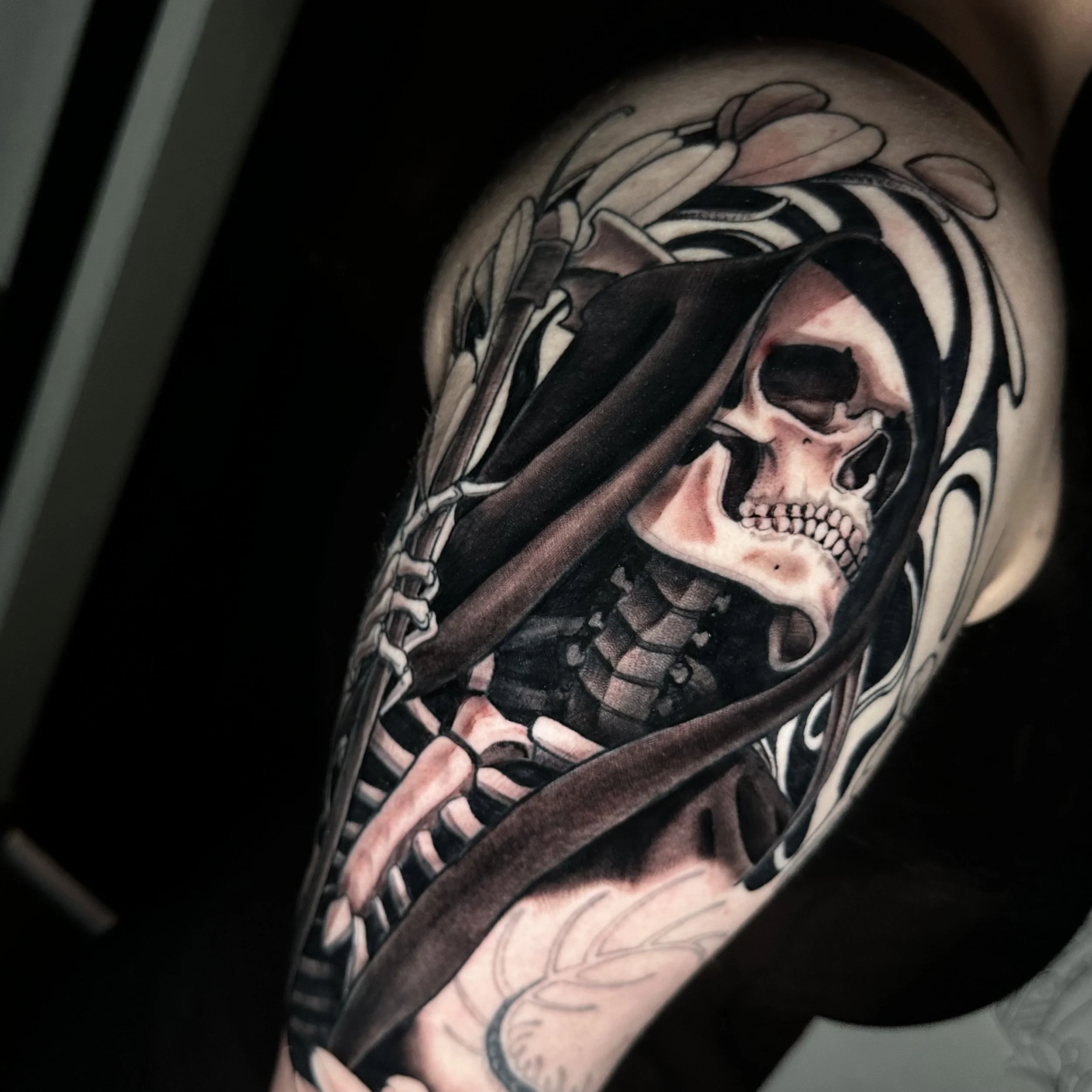 Black and gray tattoo of a reaper on an upper arm by edgar rodriguez in colorado springs