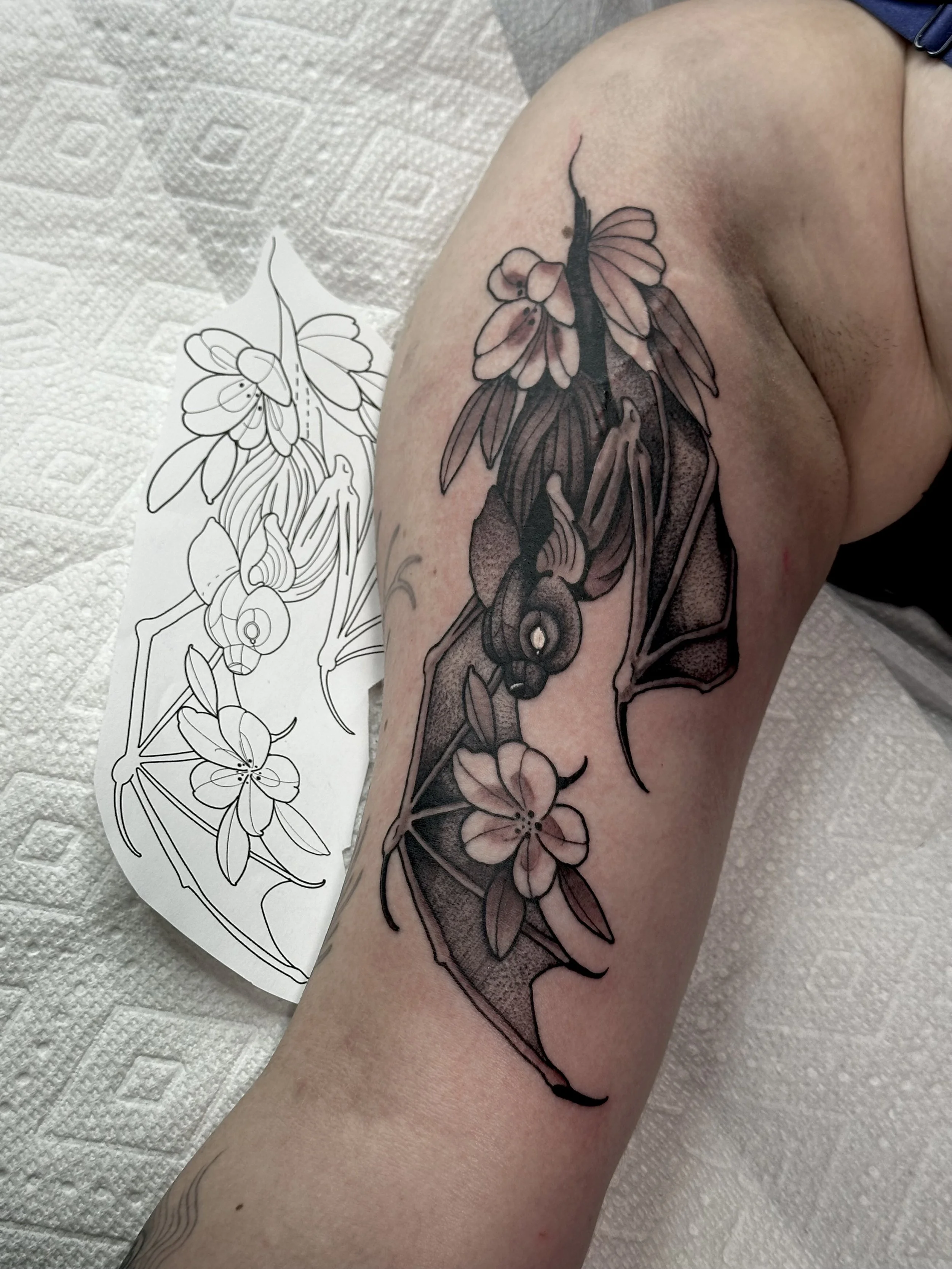 cute bat tattoo on bicep, flowers, floral, illustrative, pre drawn flash, cute tattoo, colorado springs tattoo artist