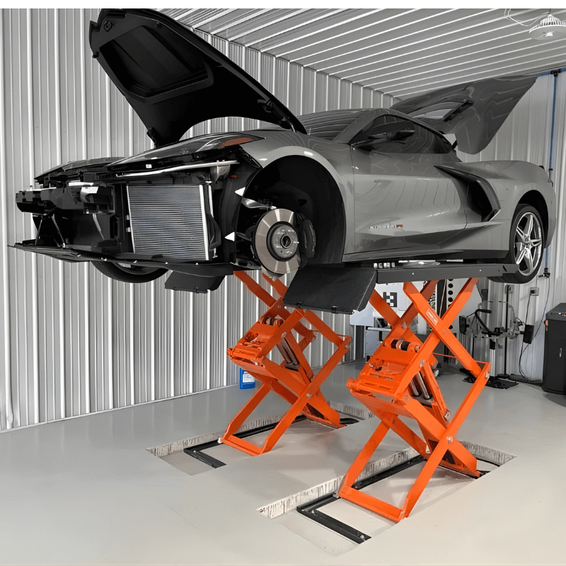 Lift arms positioned under vehicle for auto body repair work
