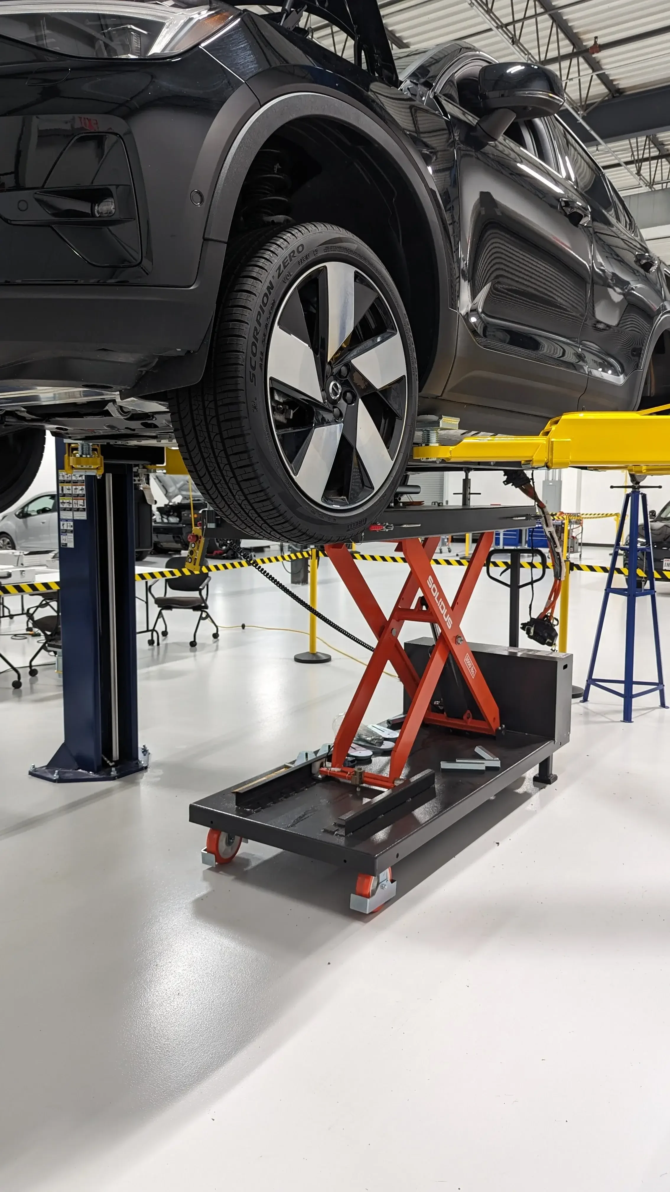 Solidus Lift in a collision repair shop holding up car