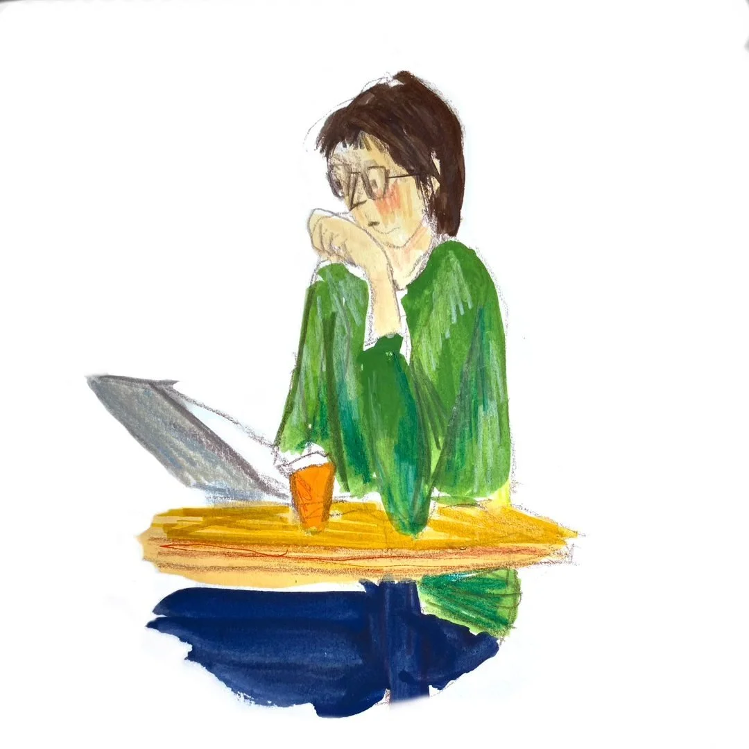 A watercolor illustration of a woman with short dark hair and glasses, resting her chin on her hand while sitting at a wooden table with a laptop and a cup.
