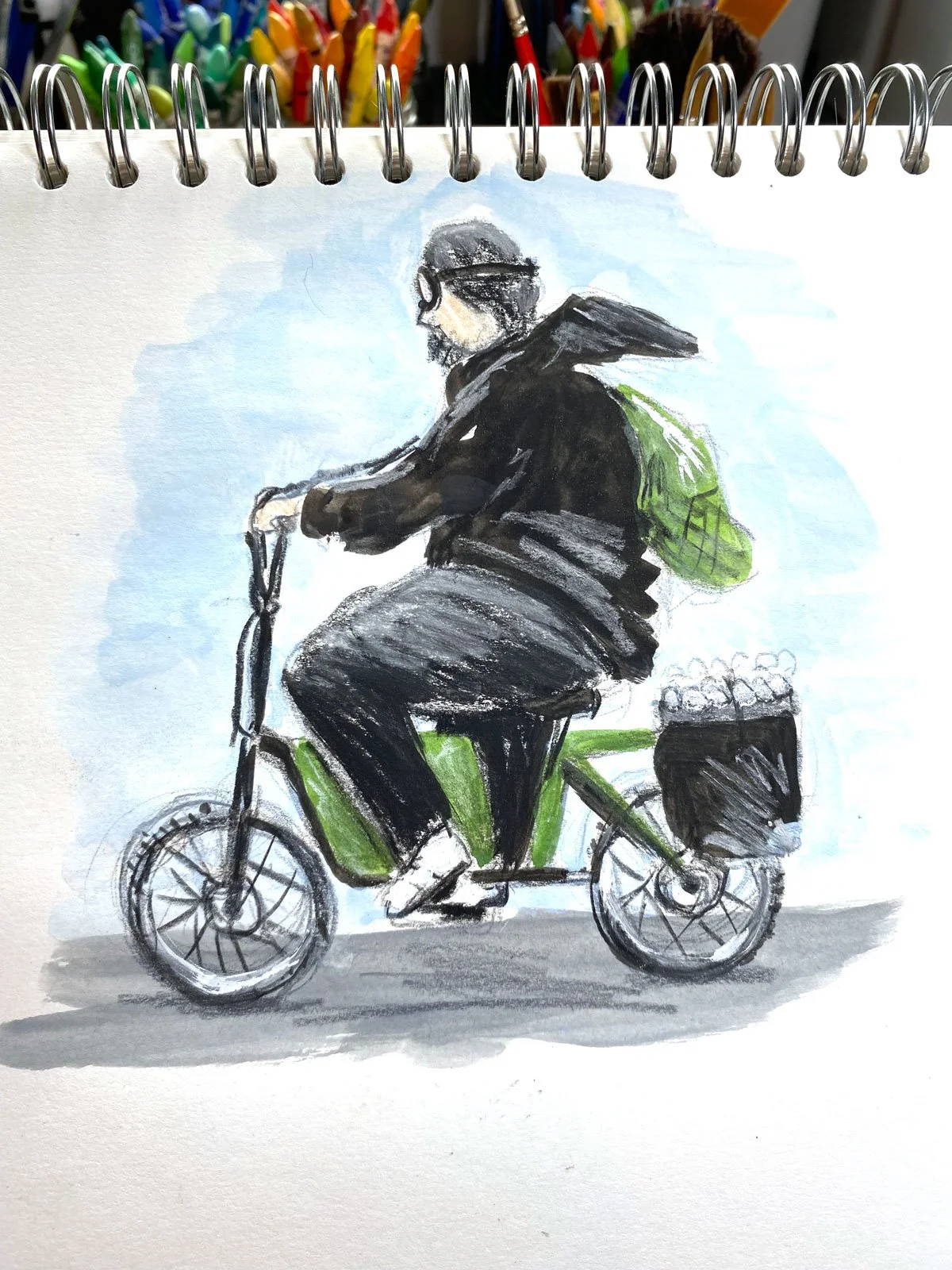 A watercolor painting of a man riding a green electric scooter with a black basket filled with coconuts on the back, wearing a black jacket, pants, helmet, and sunglasses, with a light blue sky background.