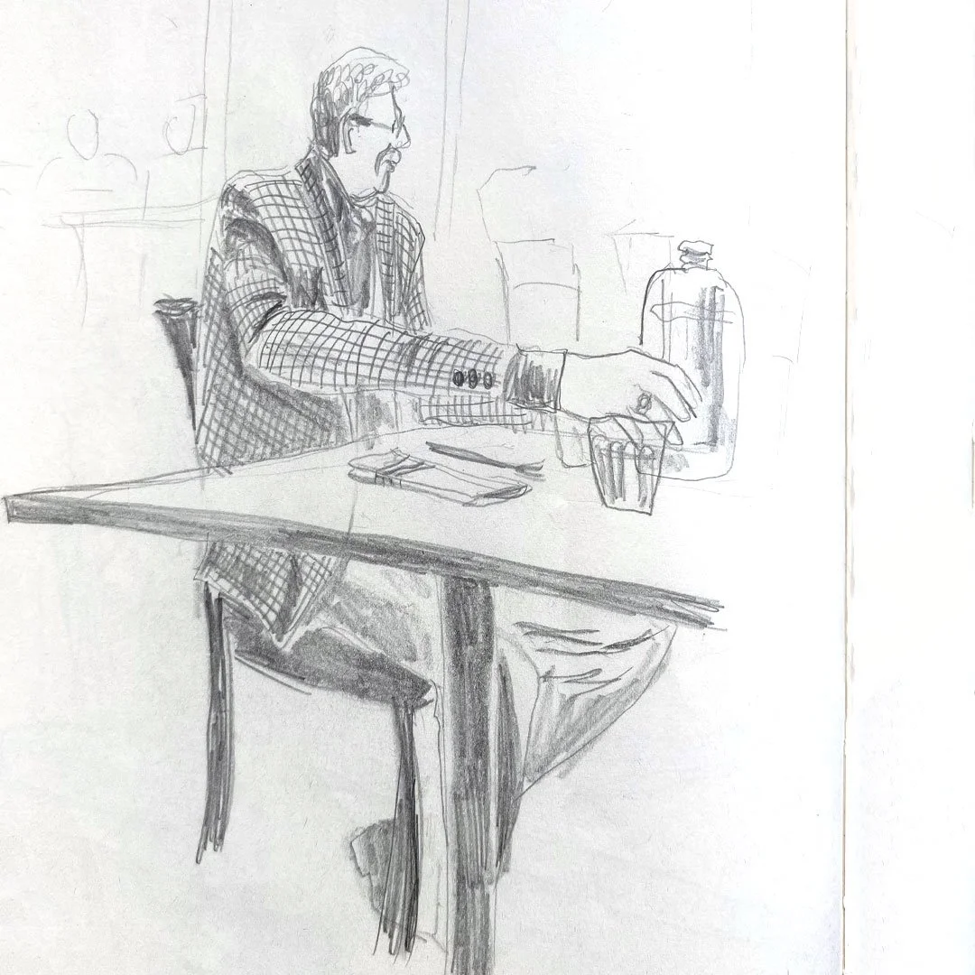 A pencil sketch of a man with glasses and a mustache, seated at a table, wearing a checkered blazer, reaching for a glass on the table. There is a water bottle and a glass in front of him.