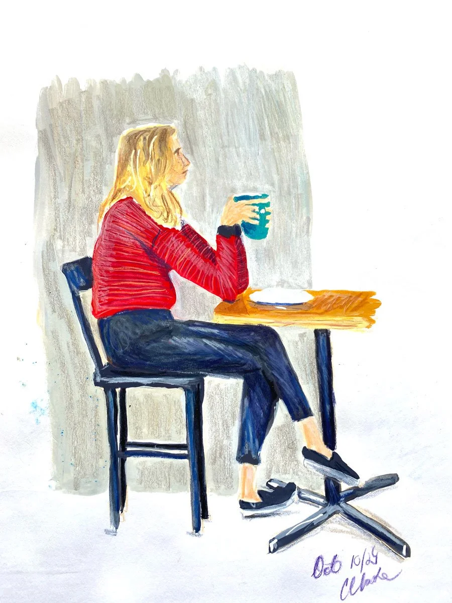 Watercolor painting of a woman with blonde hair sitting at a wooden table, holding a mug, wearing a red sweater and dark pants.