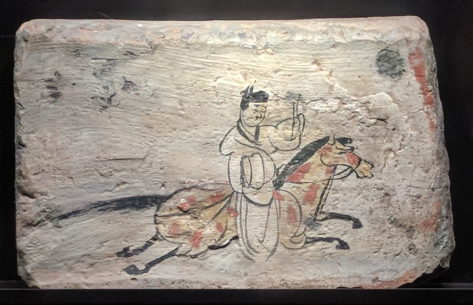 A painted mural depicts mounted horse messengers and hunters from the tombs at Jiayuguan, Gansu, c. 3rd century CE