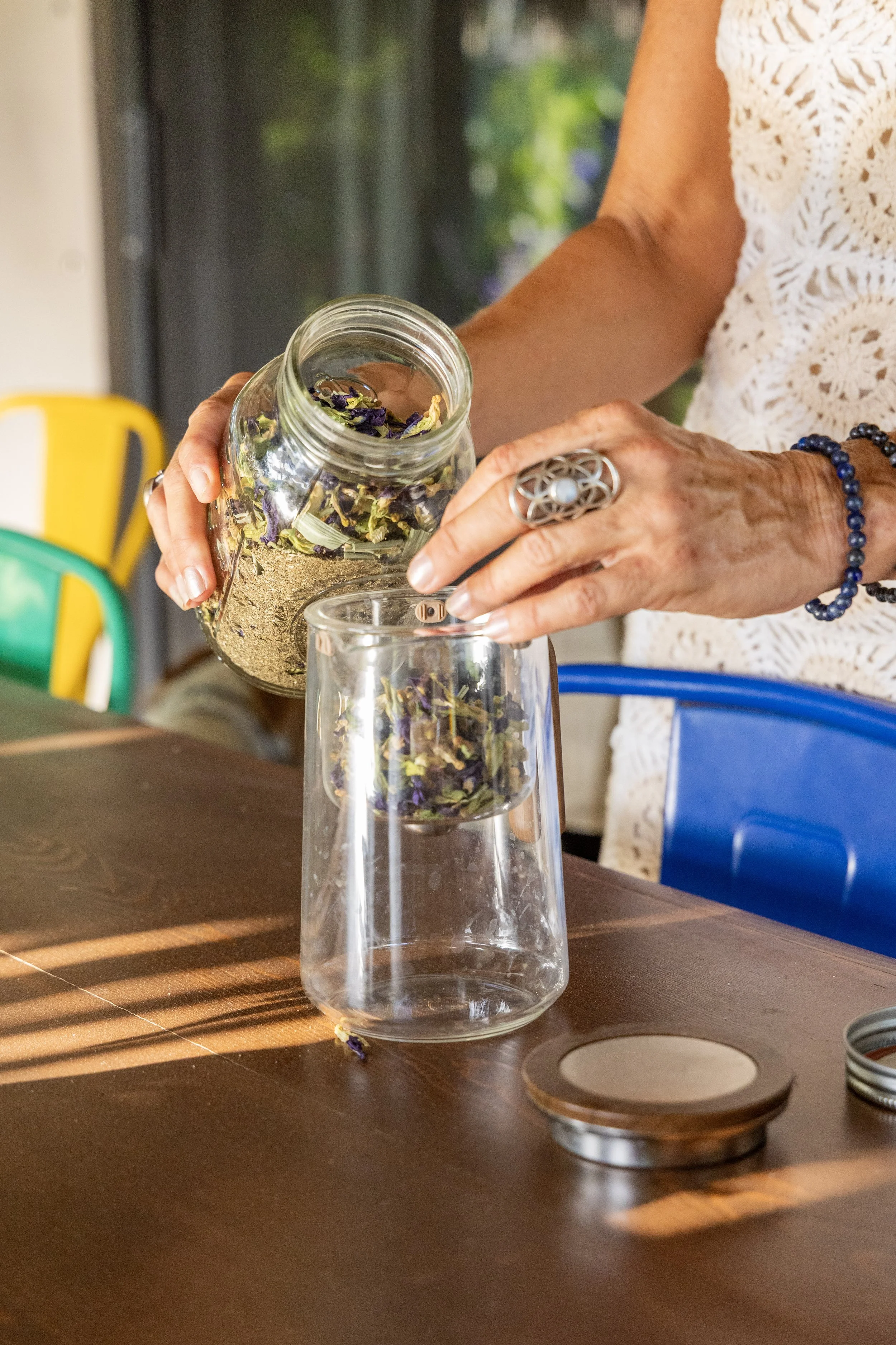 Blending dried botanicals for herbal tea at herbalism retreat Mexico