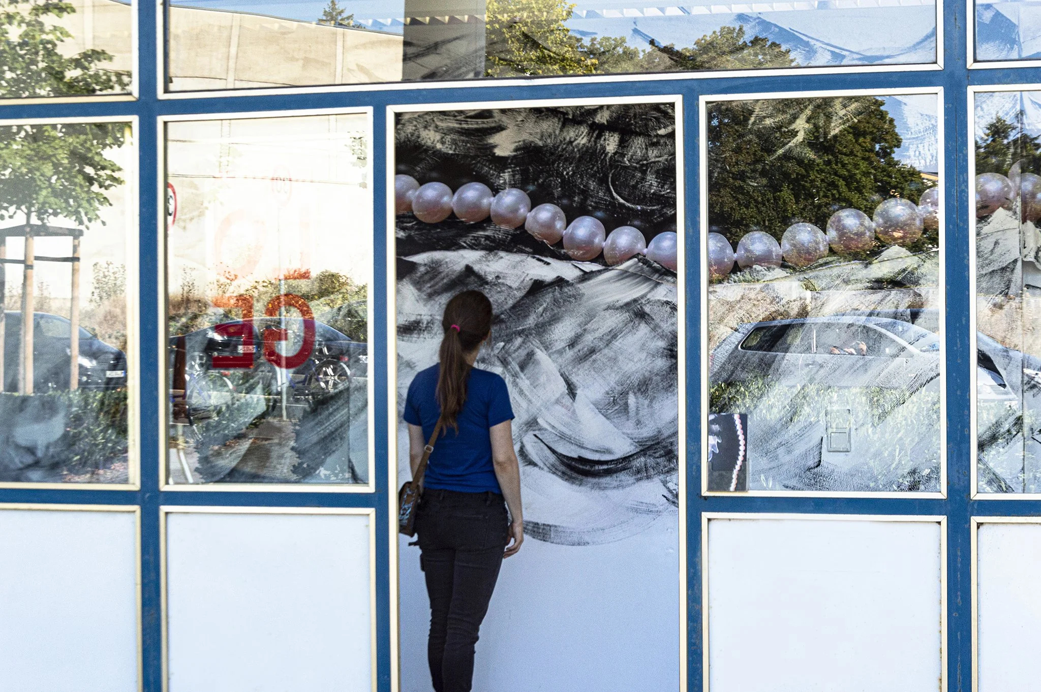 Venus Walks on Pearls 2022 view of original installation in Germany, print on paper, paint, wheat paste, faux pearls, tulle, paint scraps collected from artists, repurposed computer, tv & ipad screens,