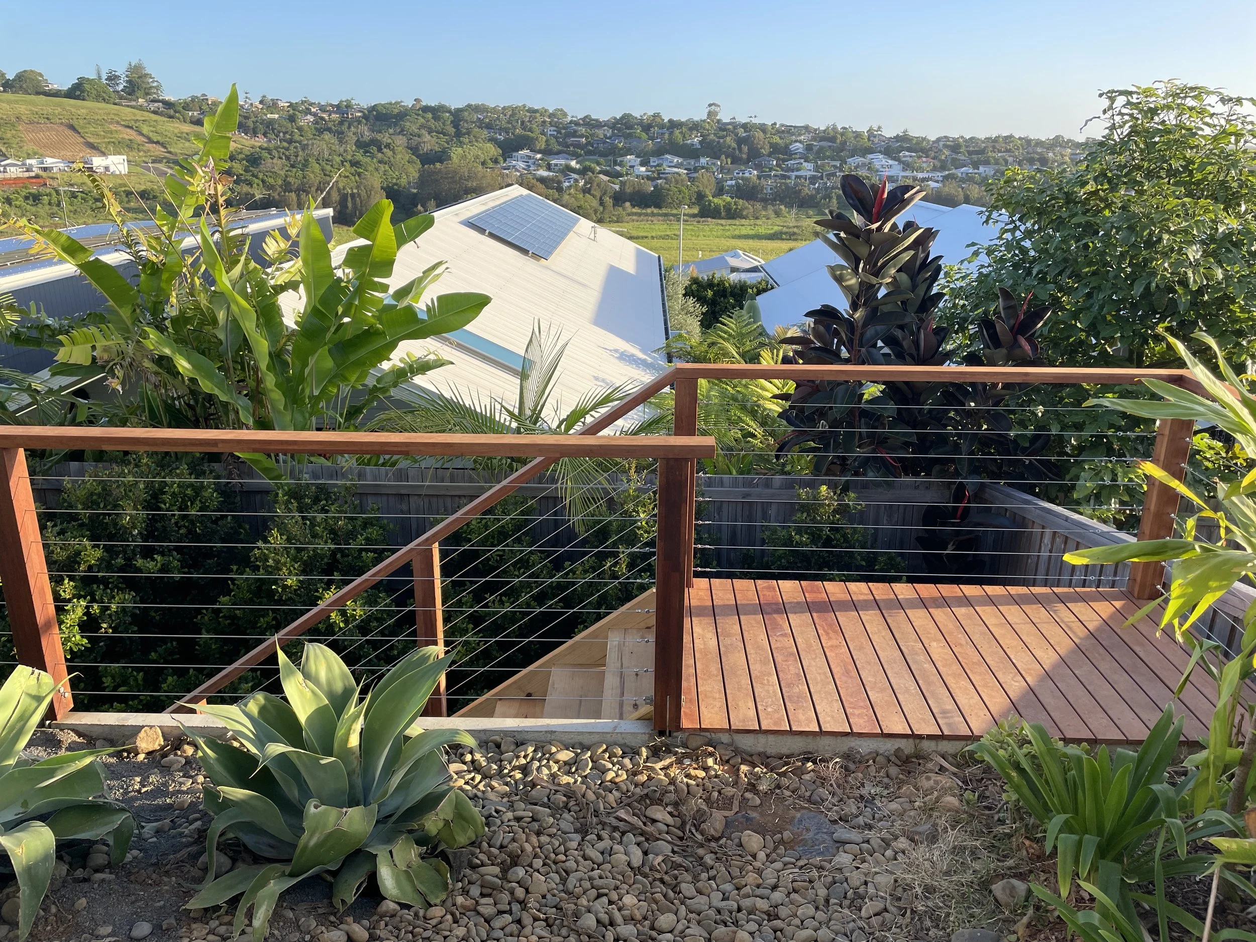 suspended merbau deck, pine staircase and merbau handrail with stainless wire balustrade