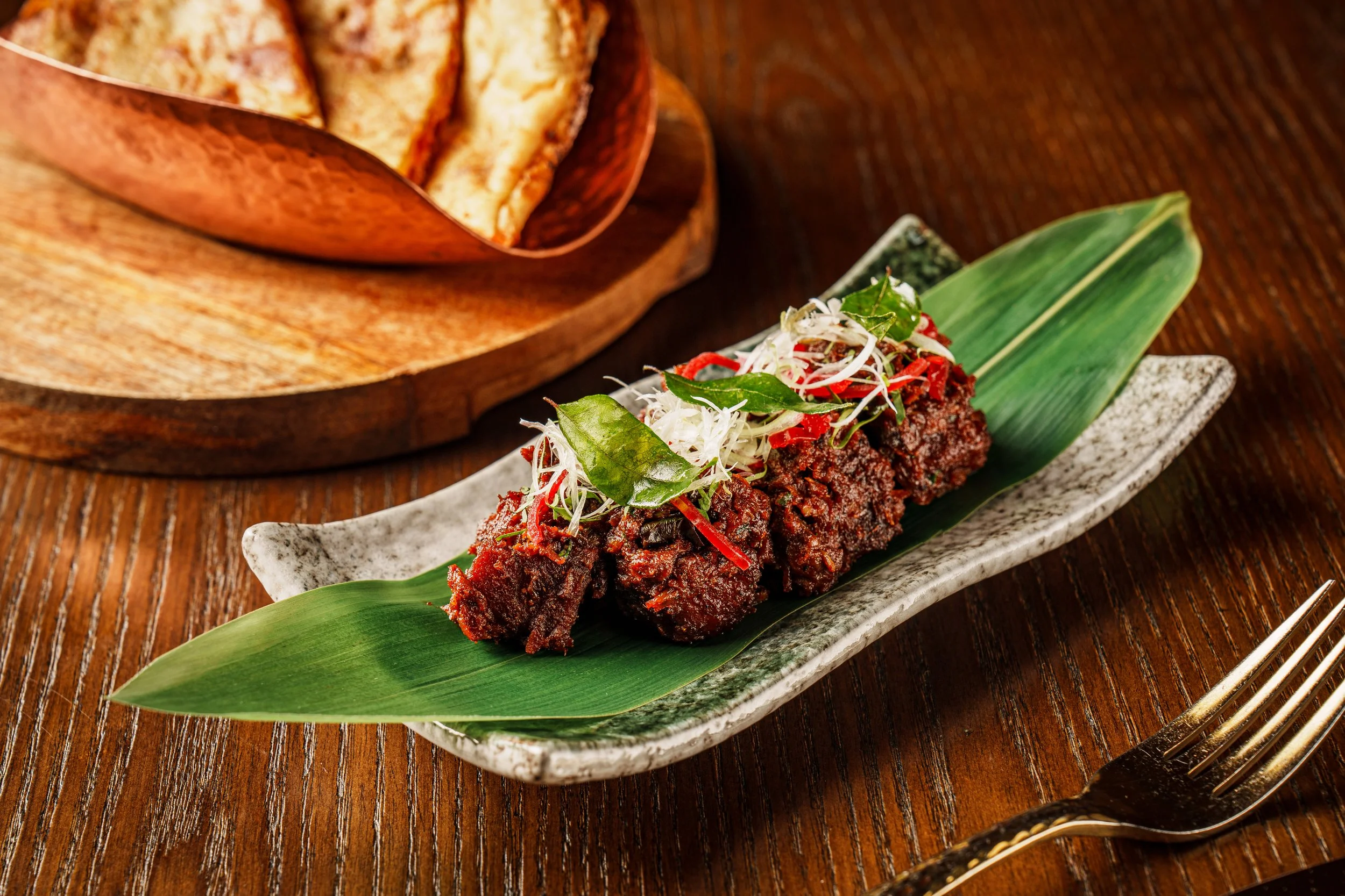 A wok‑fried creation that nods to Hong Kong’s street kitchens, this dish plays on southern Indian flavours with Sichuan pepper and curry leaf, best enjoyed with naan.