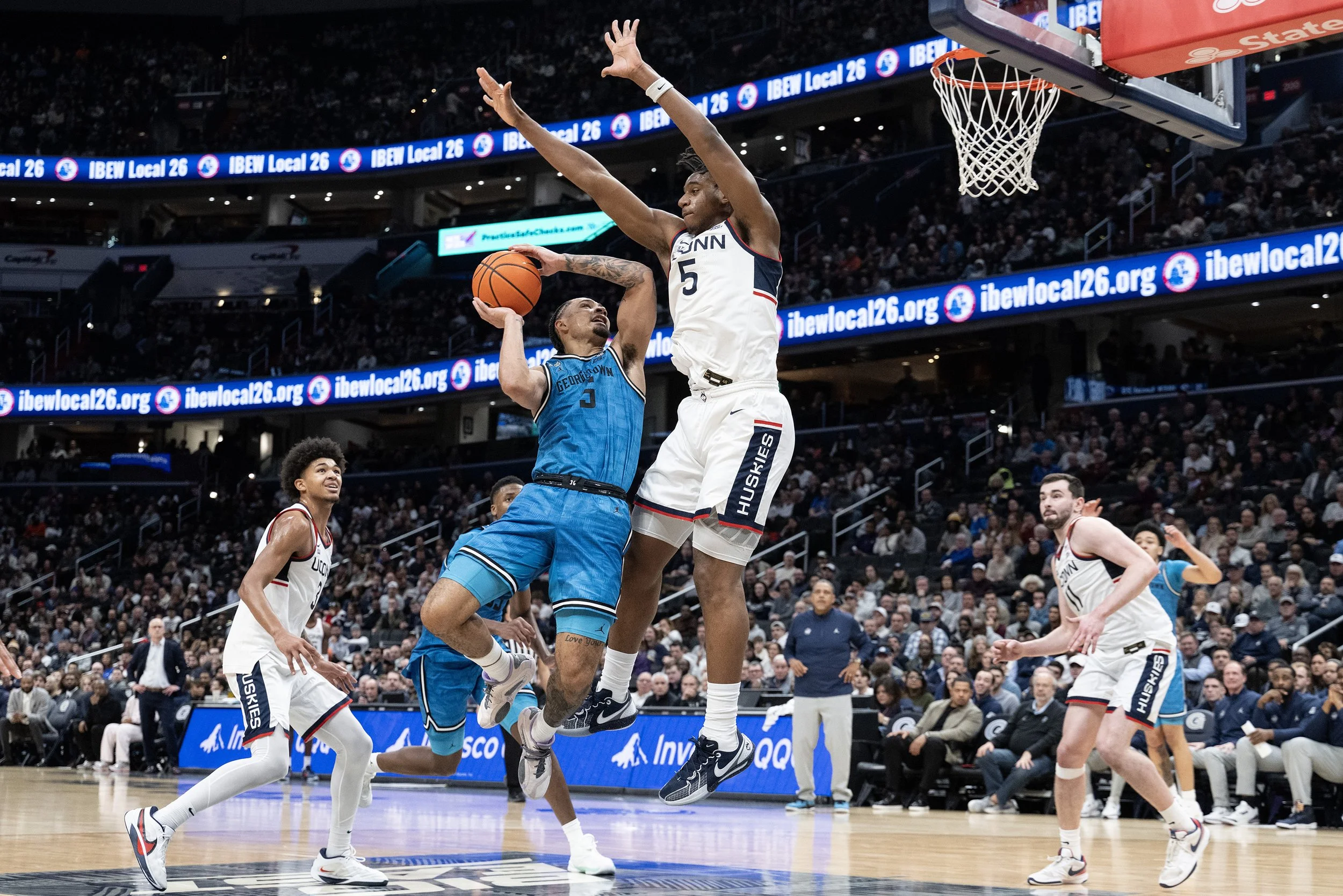 Georgetown University graduate forward Micah Peavy, 5, gets blocked in the second half by University of Connecticut junior center Tarris Reed Jr., 5, as Georgetown plays number 9 UConn Jan. 11, 2025, at Capital One Arena in Washington, D.C. 