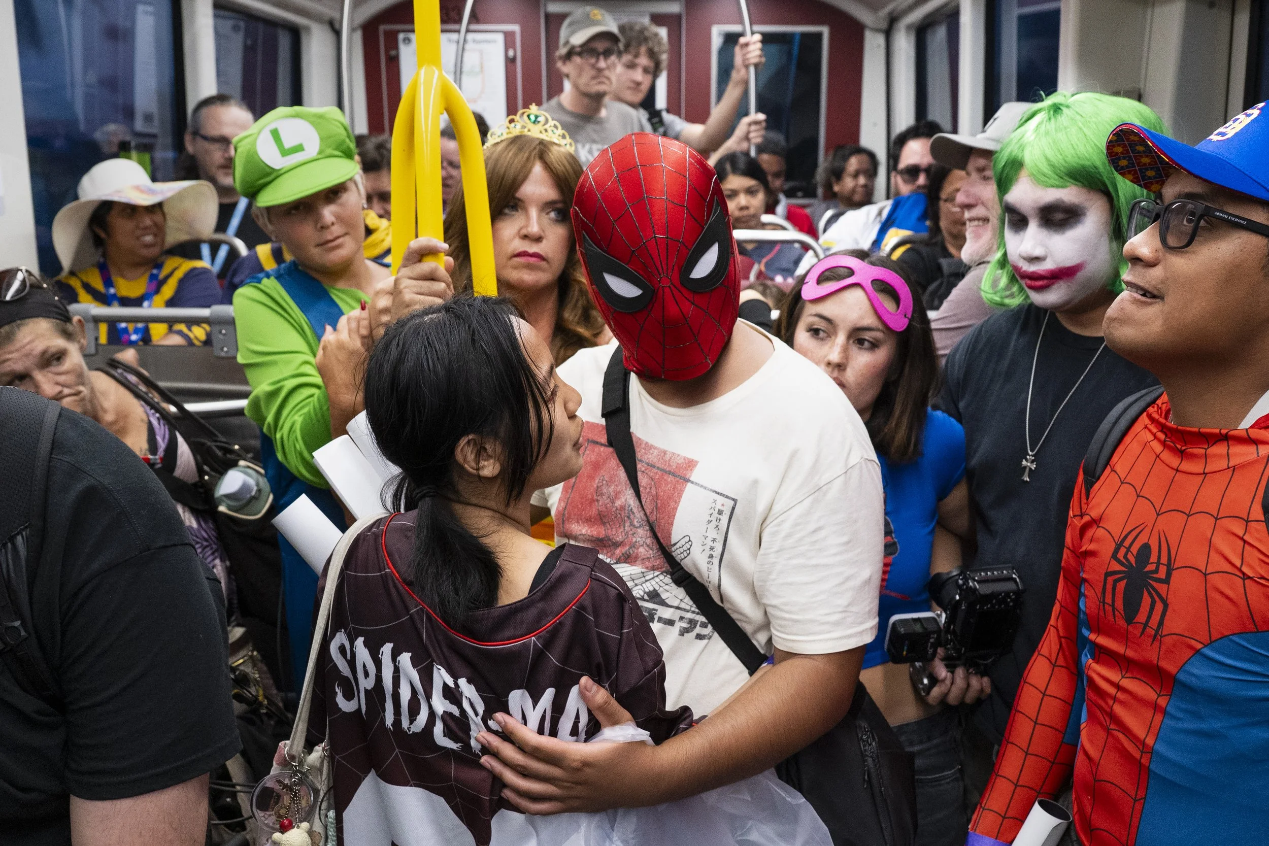 People dressed as characters ranging from the DC Universe to Nintendo, pack the green line trolley July 24, 2026, after leaving the San Diego Convention Center as Comic-Con closed for the day in San Diego, Calif.