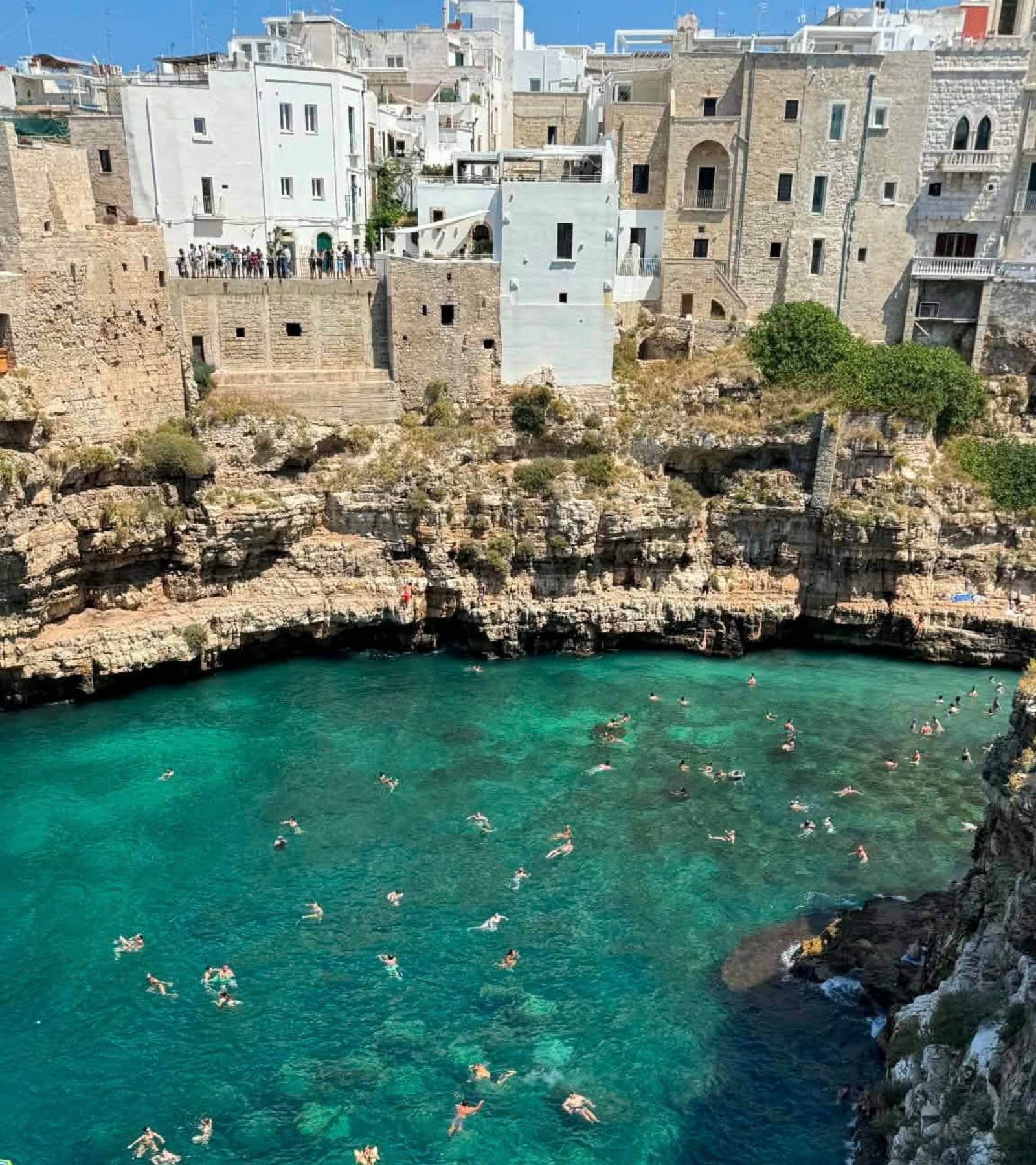 A view of people swimming in Polignano a Mare in Puglia