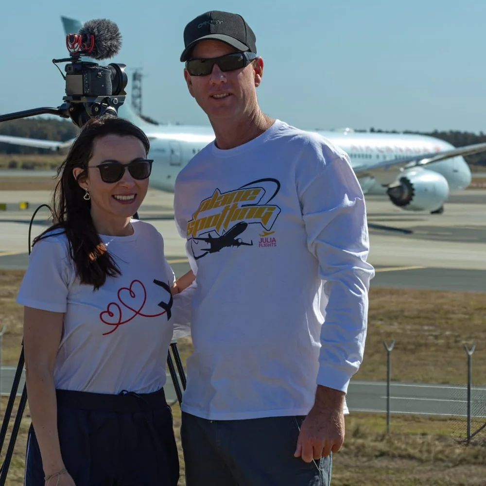Julia and Gavin wearing Julia Flights merch at the airport