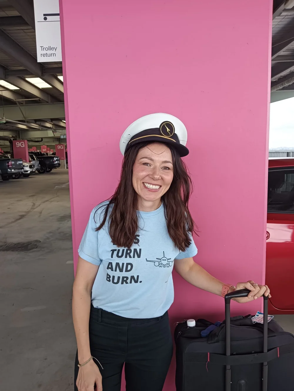 Fan in a captain hat wearing the Turn and Burn tee