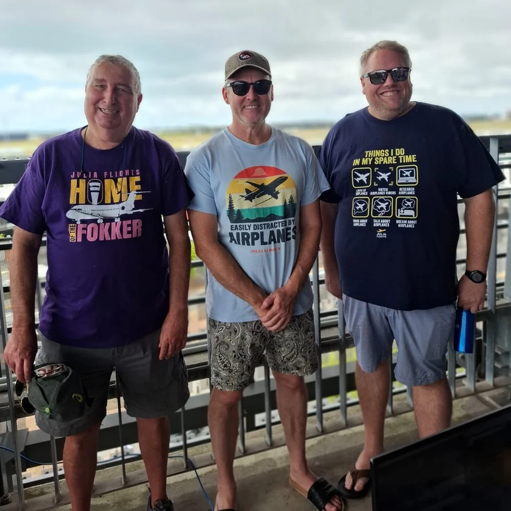 Three fans wearing Julia Flights tees at the airport