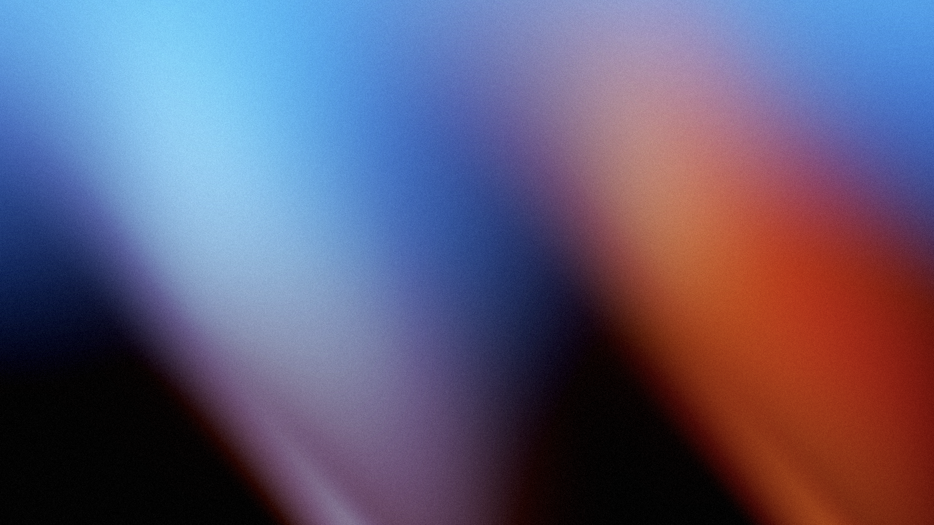 Blurred abstract background with a mixture of blue, black, red, purple, and orange colors.