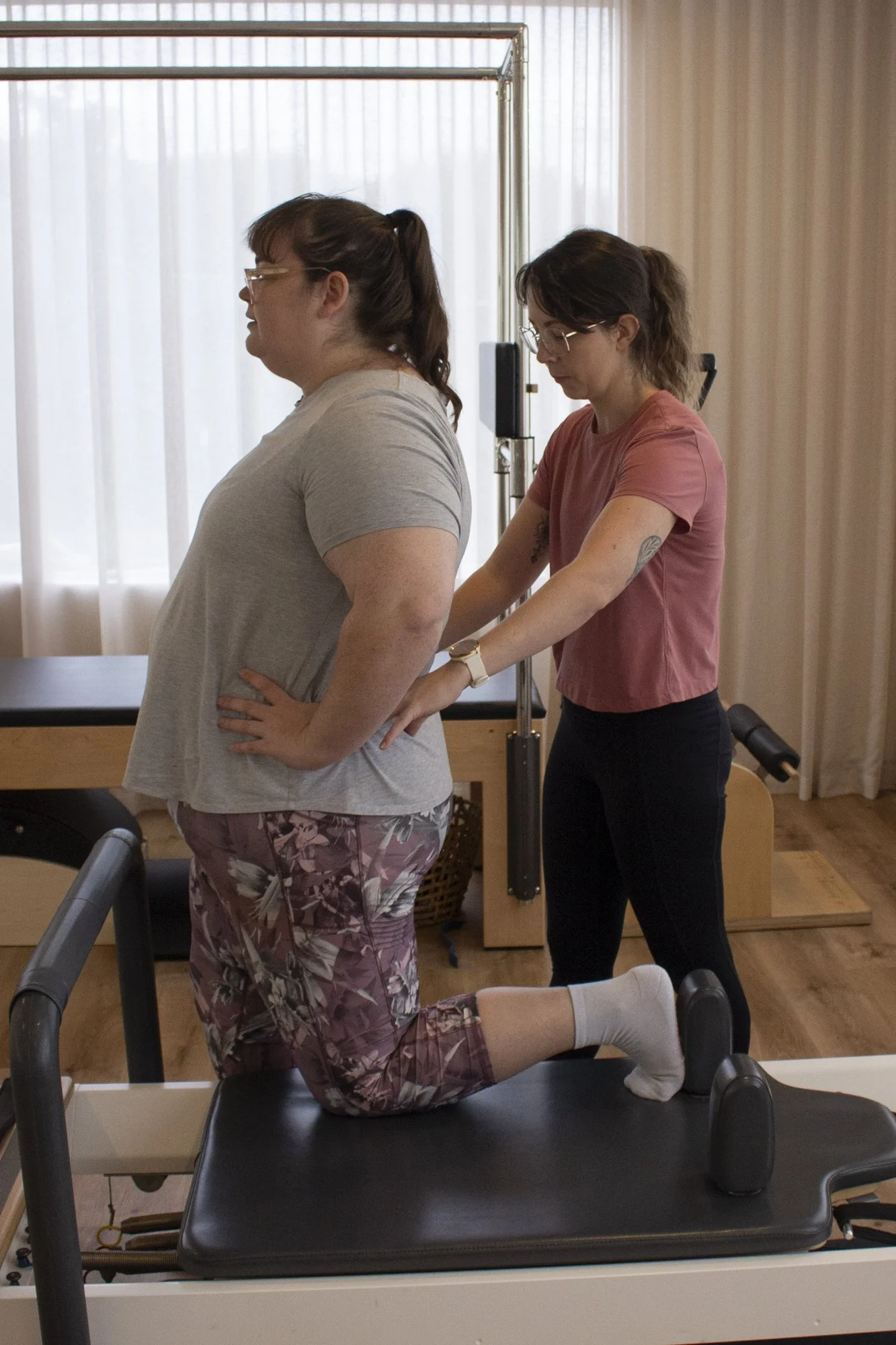 Exercise Physiologist guiding a client through movement at any.BODY