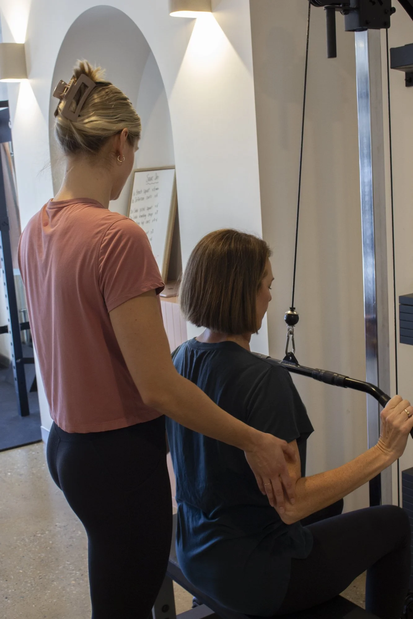 Small-group strength coaching at any.BODY with dumbbell rows