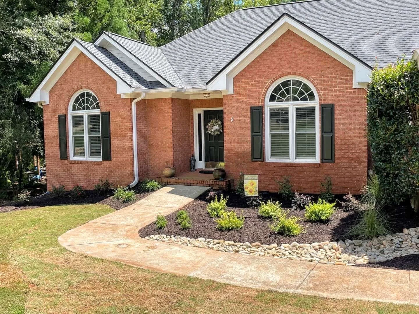 Dry creek bed and planters in front yard