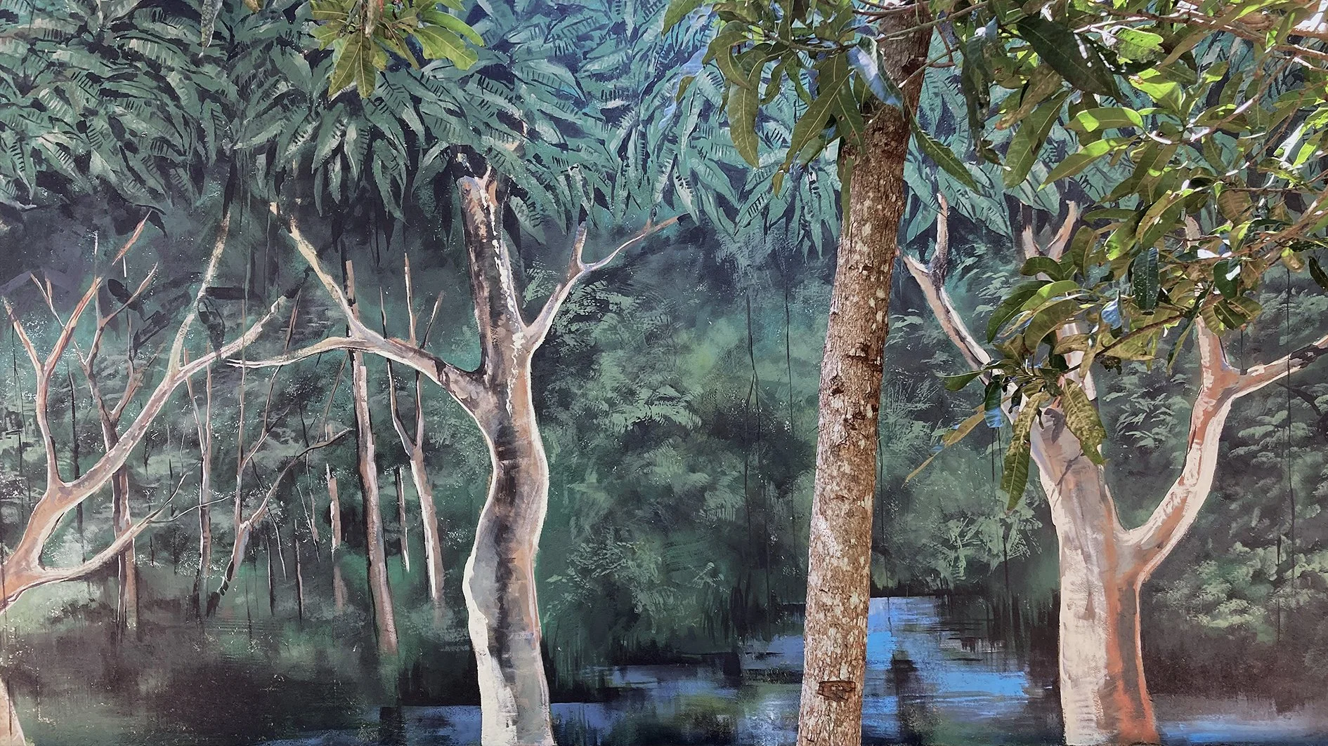 A mural or painting depicting a dense forest scene with trees, foliage, and water, creating an immersive nature landscape.