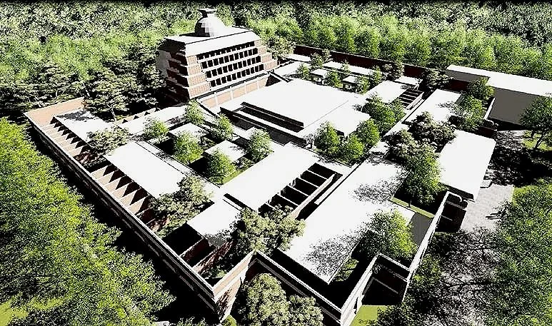 Aerial view of a modern building complex surrounded by trees and greenery.