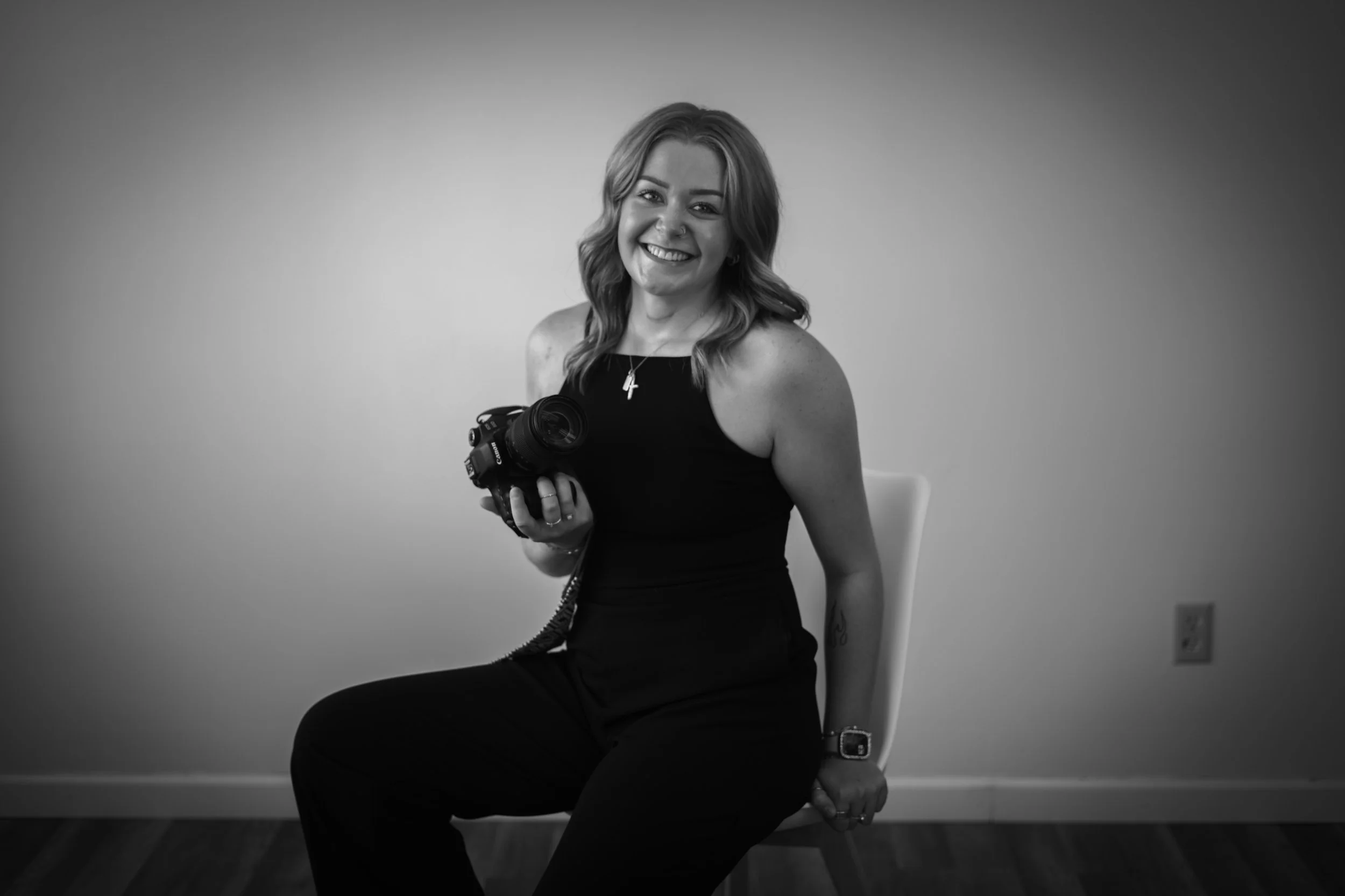 A woman with in studio holding a camera. Minnesota Photographer. Travel Photographer.