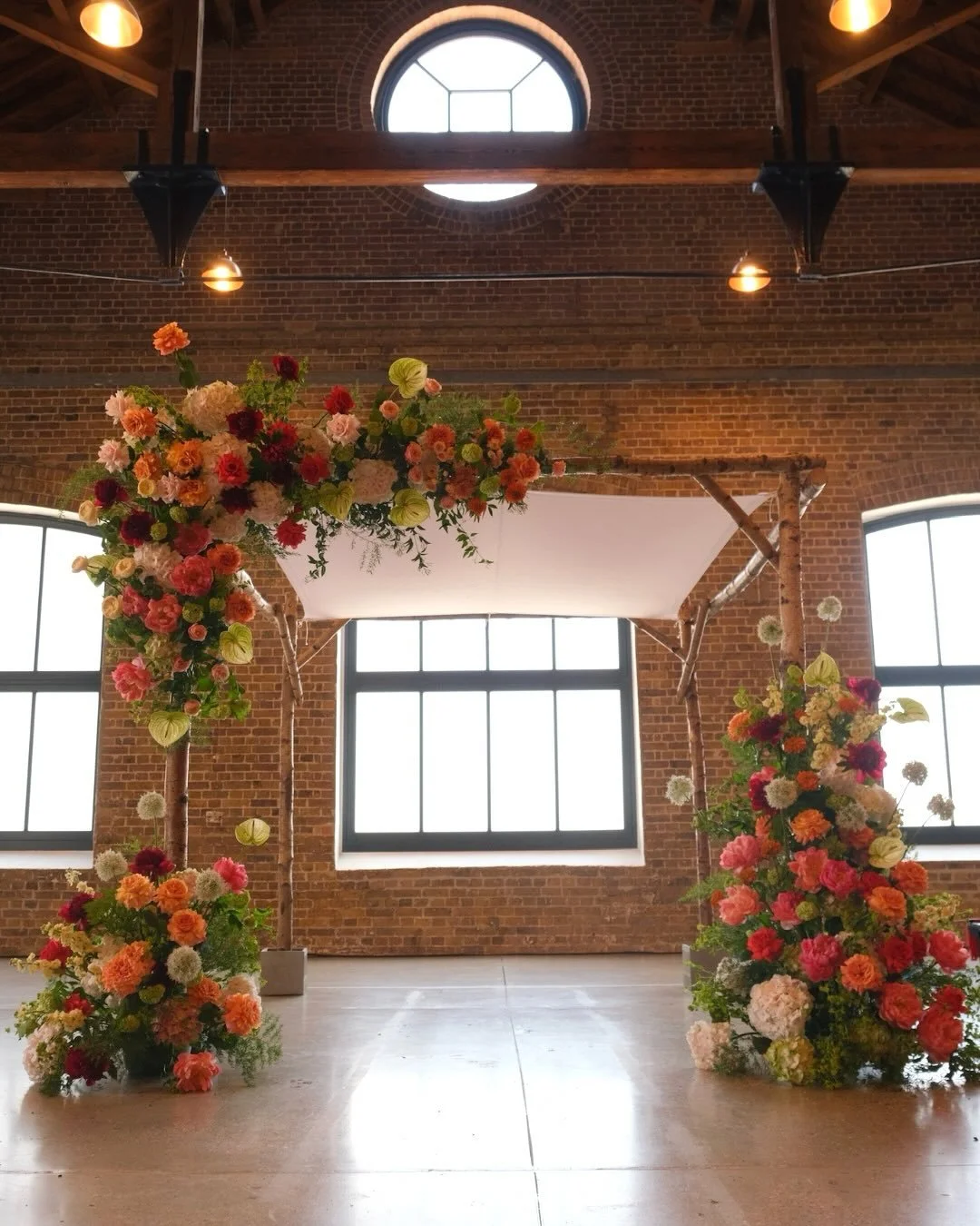 A chuppah in the making 🧡🌹 a statement backdrop for our amazing clients Nina &amp; Matt. They wanted the urban backdrop of @trinitybuoywharfweddings to feel full, luscious and packed to the bring with colour and texture!

Structure from @the_happy_
