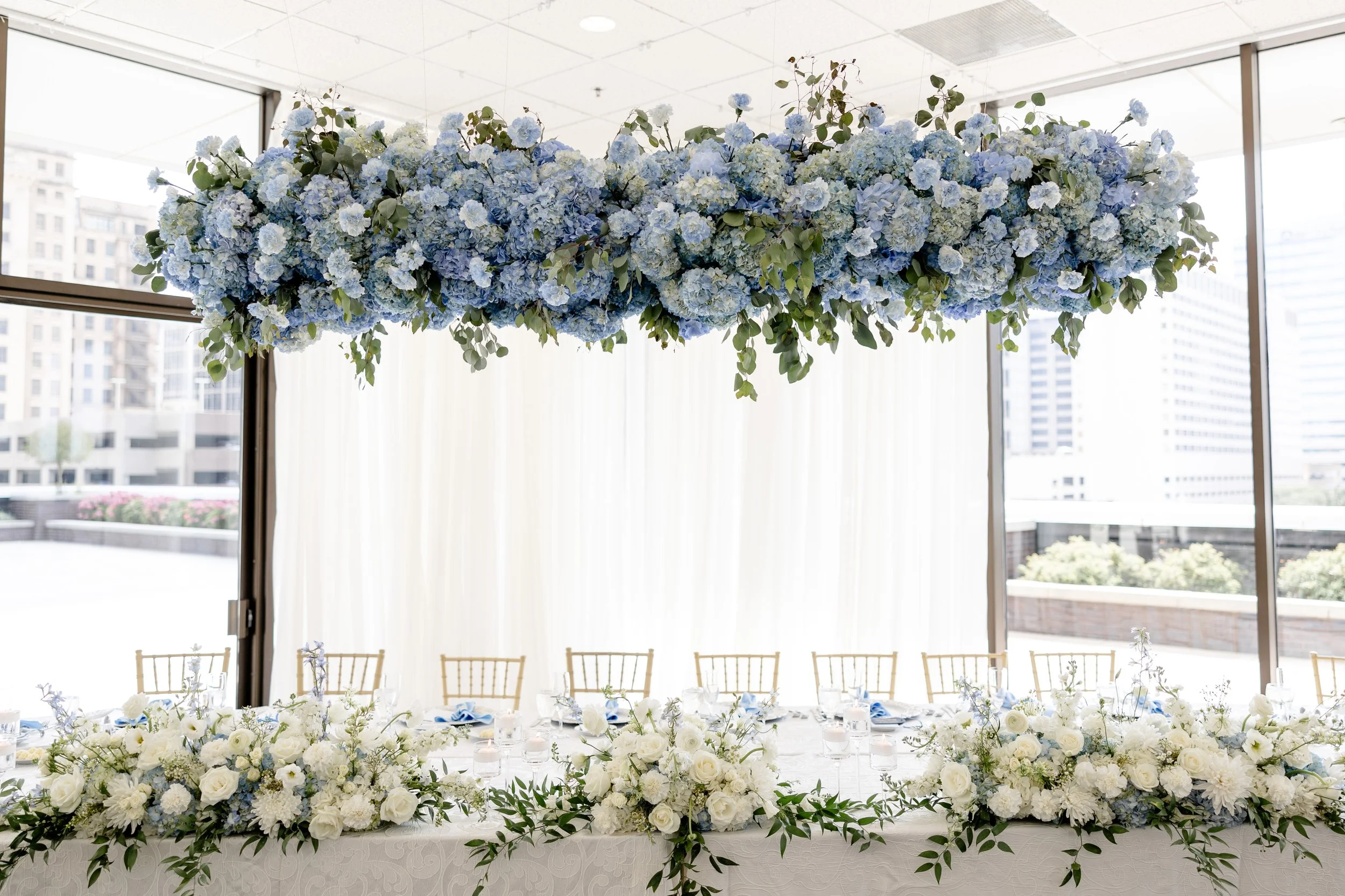 Luxury wedding head table floral installation designed by K.I.S Florals in Indianapolis, featuring lush arrangements and elevated wedding décor.
