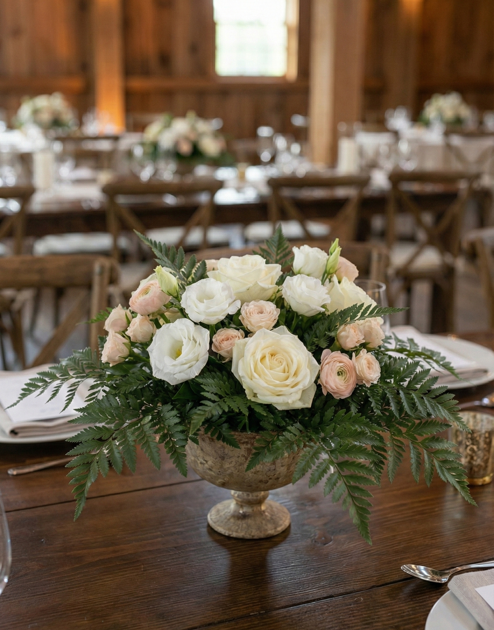 Romantic cream and blush wedding centerpiece with roses and ferns by KIS Florals, styled for a rustic Indianapolis barn wedding reception.