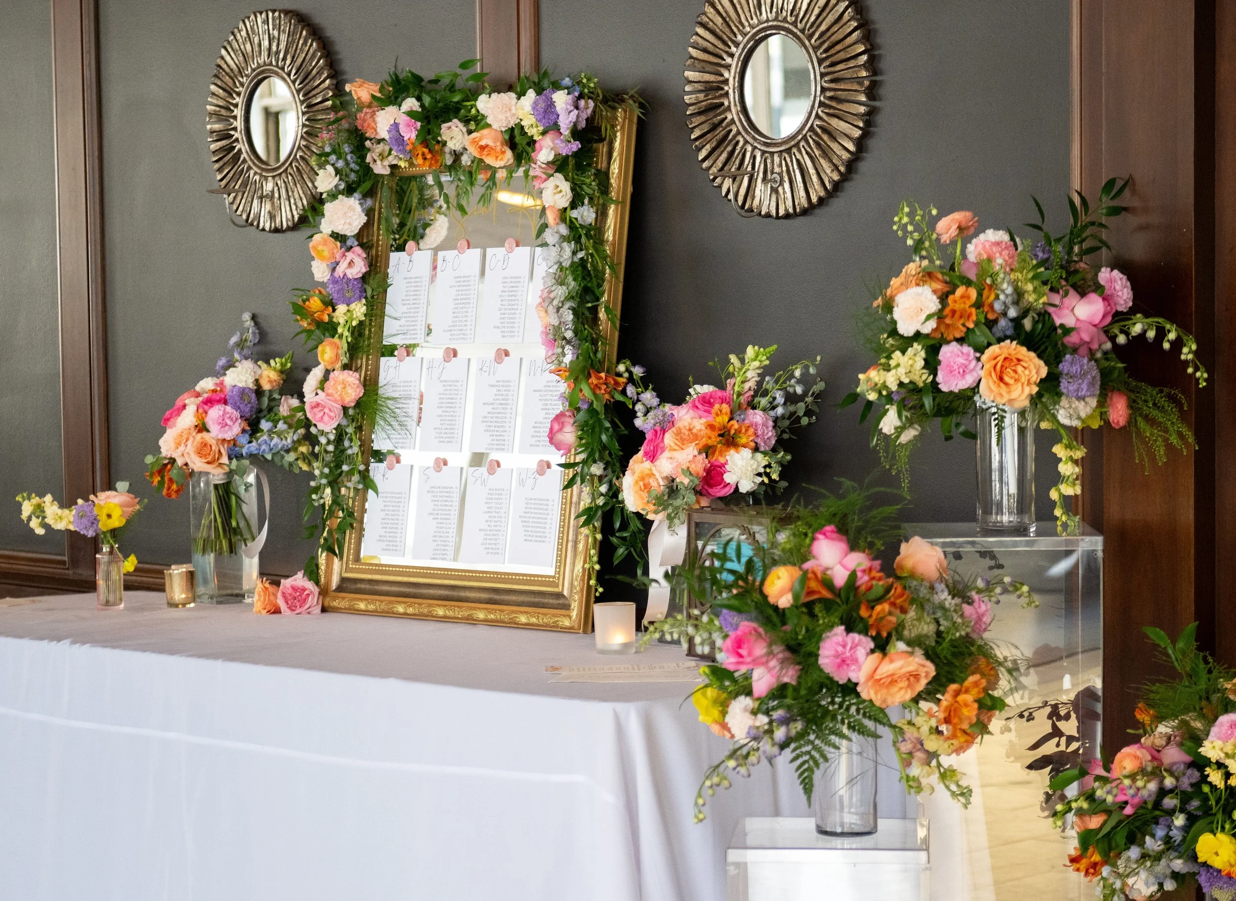 Wedding table assignment display with coordinated floral arrangements designed by K.I.S Florals in Indianapolis.
