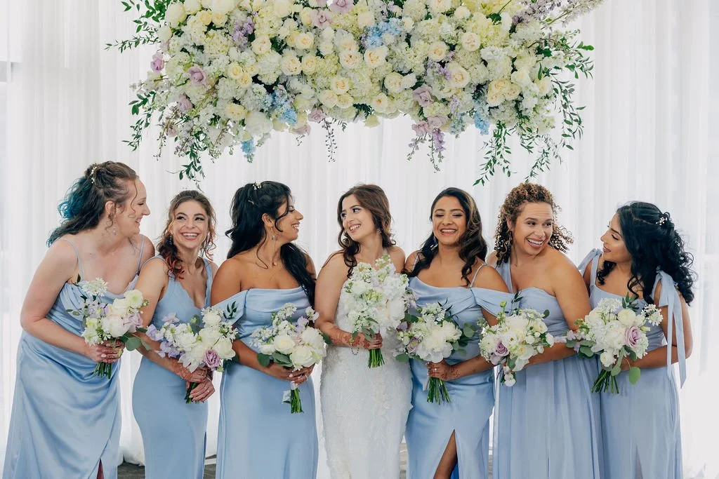Bride and bridesmaids holding coordinated wedding bouquets designed by K.I.S Florals in Indianapolis.