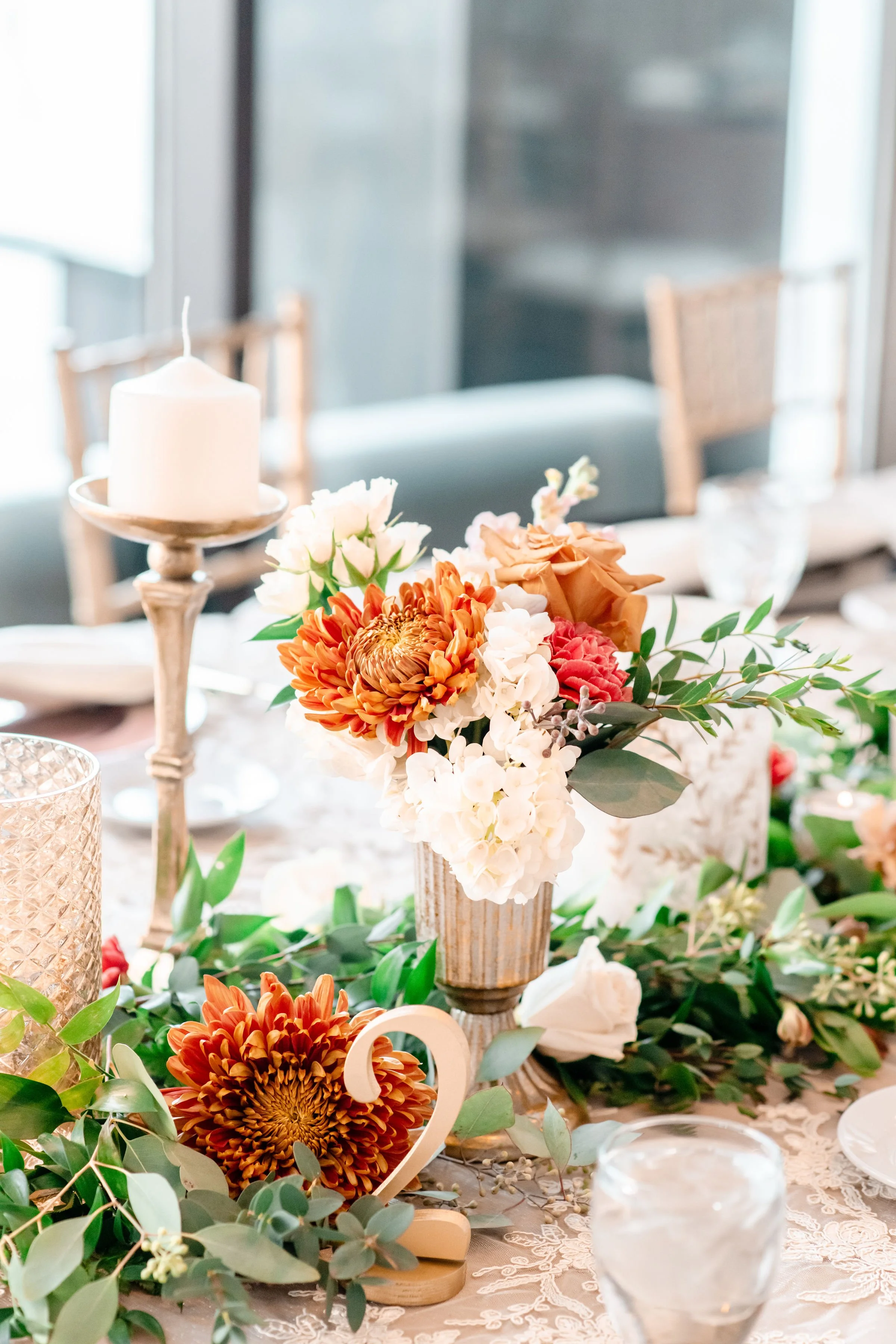 Small table arrangement paired with candles for an Indianapolis wedding reception, designed by K.I.S Florals.