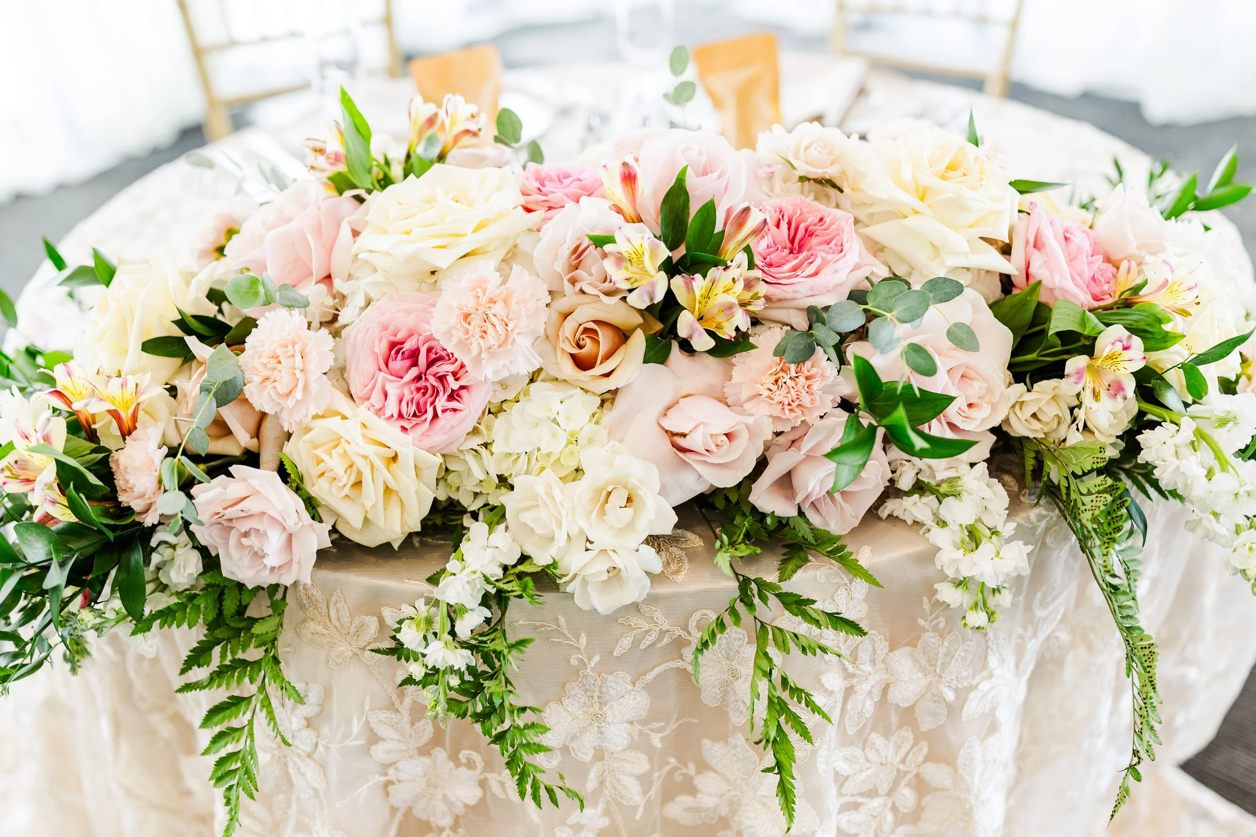 Lush floral garland running along a wedding head table designed by K.I.S Florals in Indianapolis.