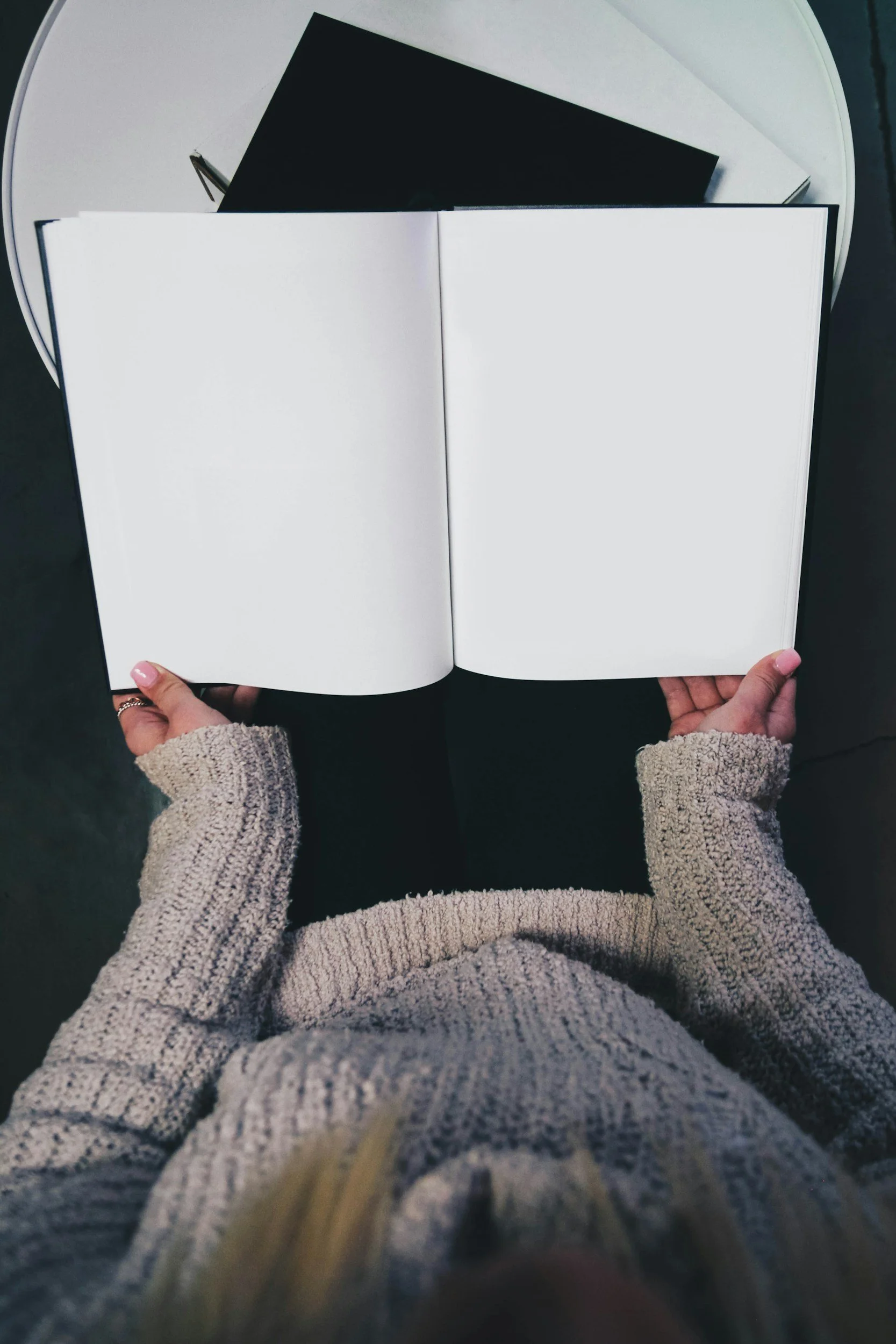 Nursing student opening a book to read