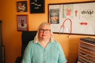 Rhoda in her office ready to talk on Zoom